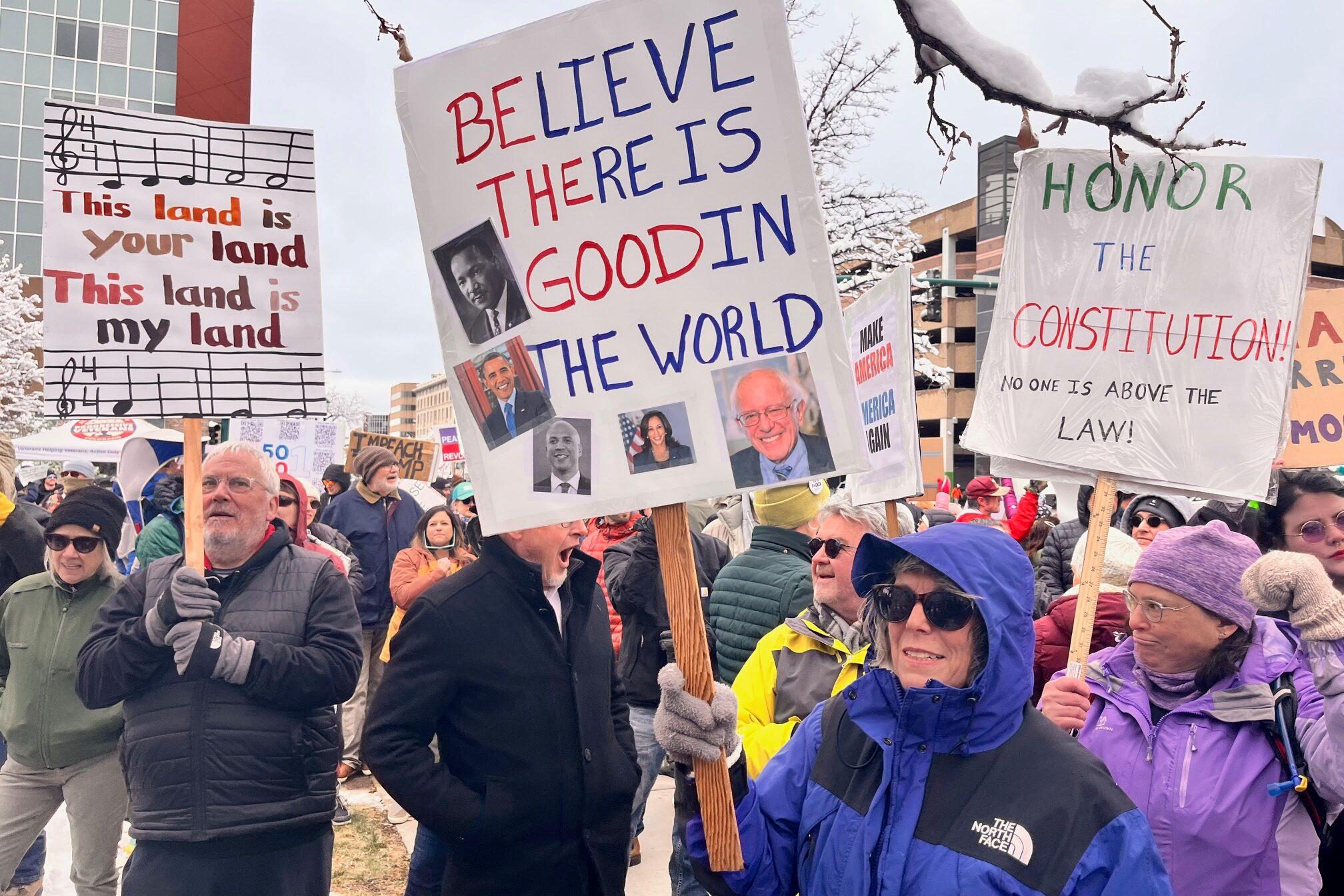 group of people holding signs