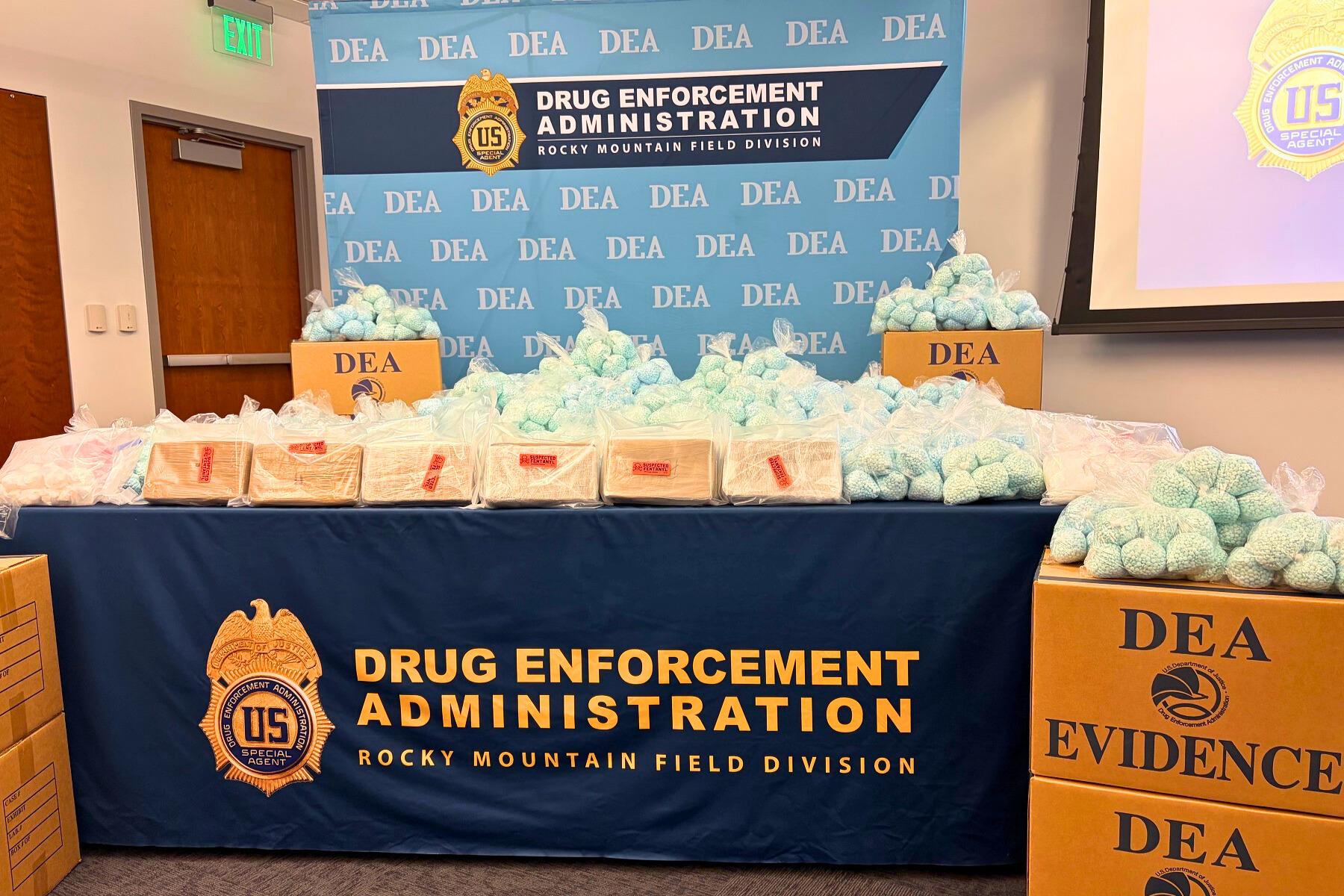 A blue tablecloth with a sign that says "Drug Enforcement Administration" on it.