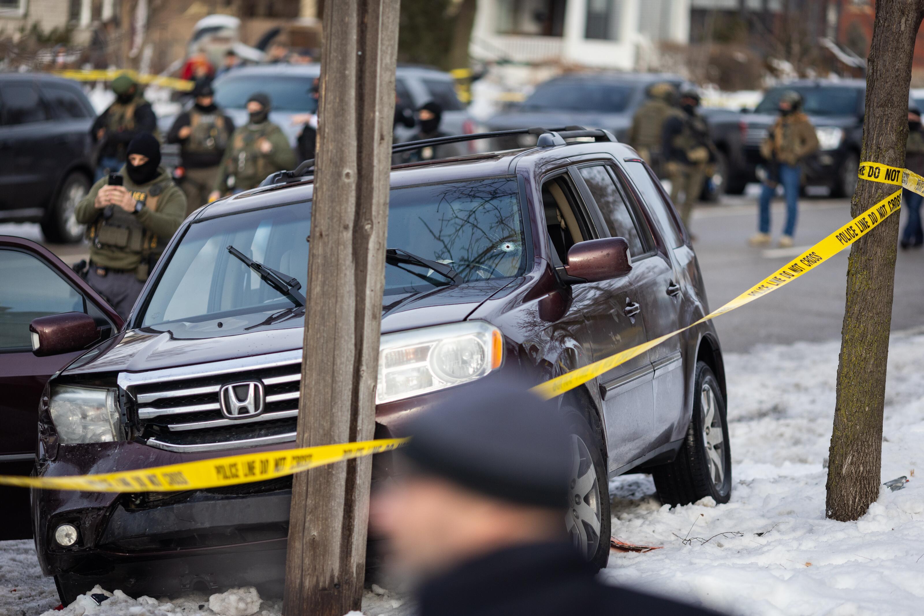 A bullet hole is visible in the windshield of a crashed vehicle on Portland Avenue in Minneapolis after an ICE officer shot and killed an observer on Wednesday, Jan. 7, 2026.