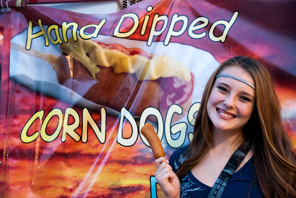 Mariah Kayton enjoys a corn dog at the fair.