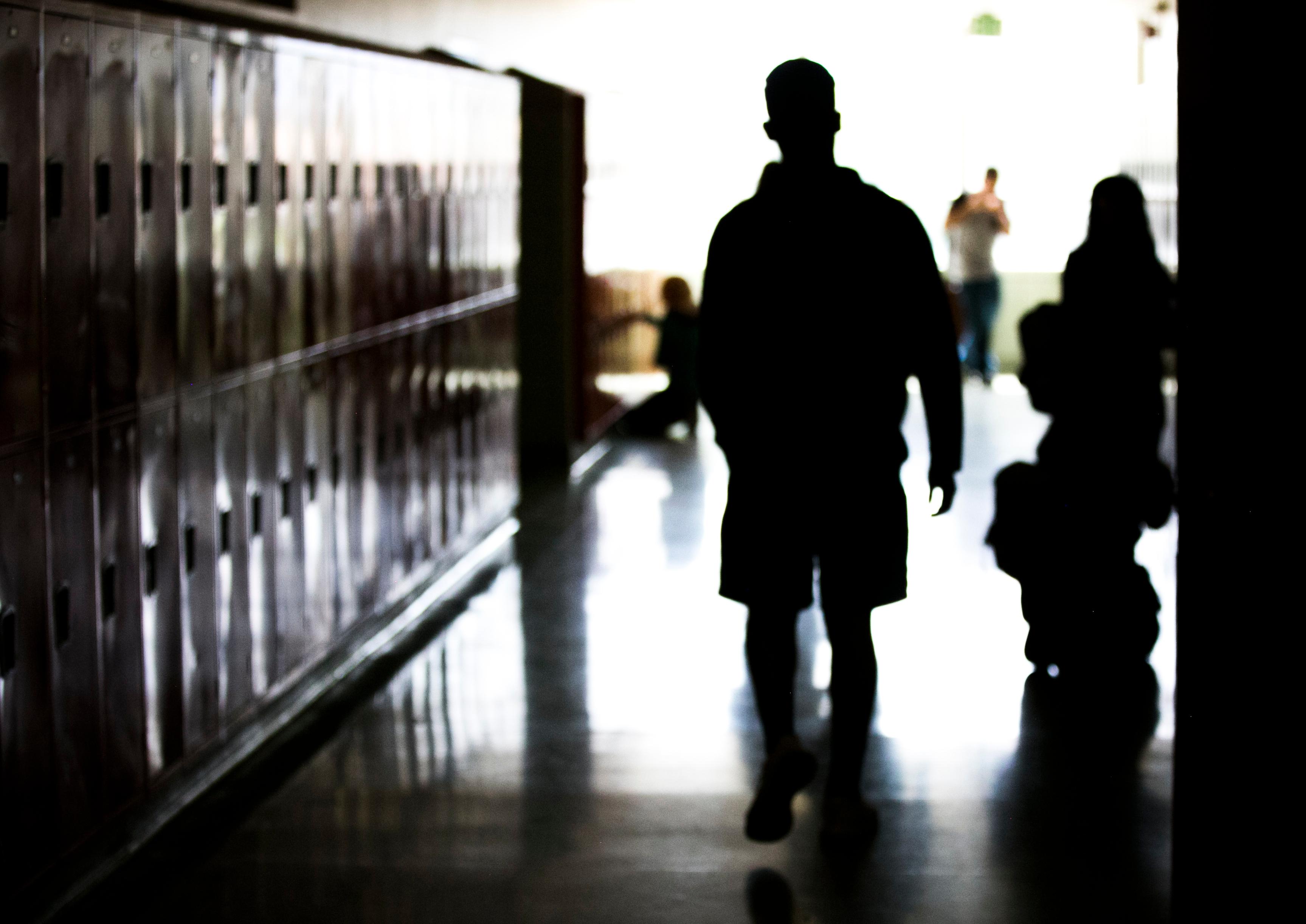 Grand Junction High School student walks down a hallway