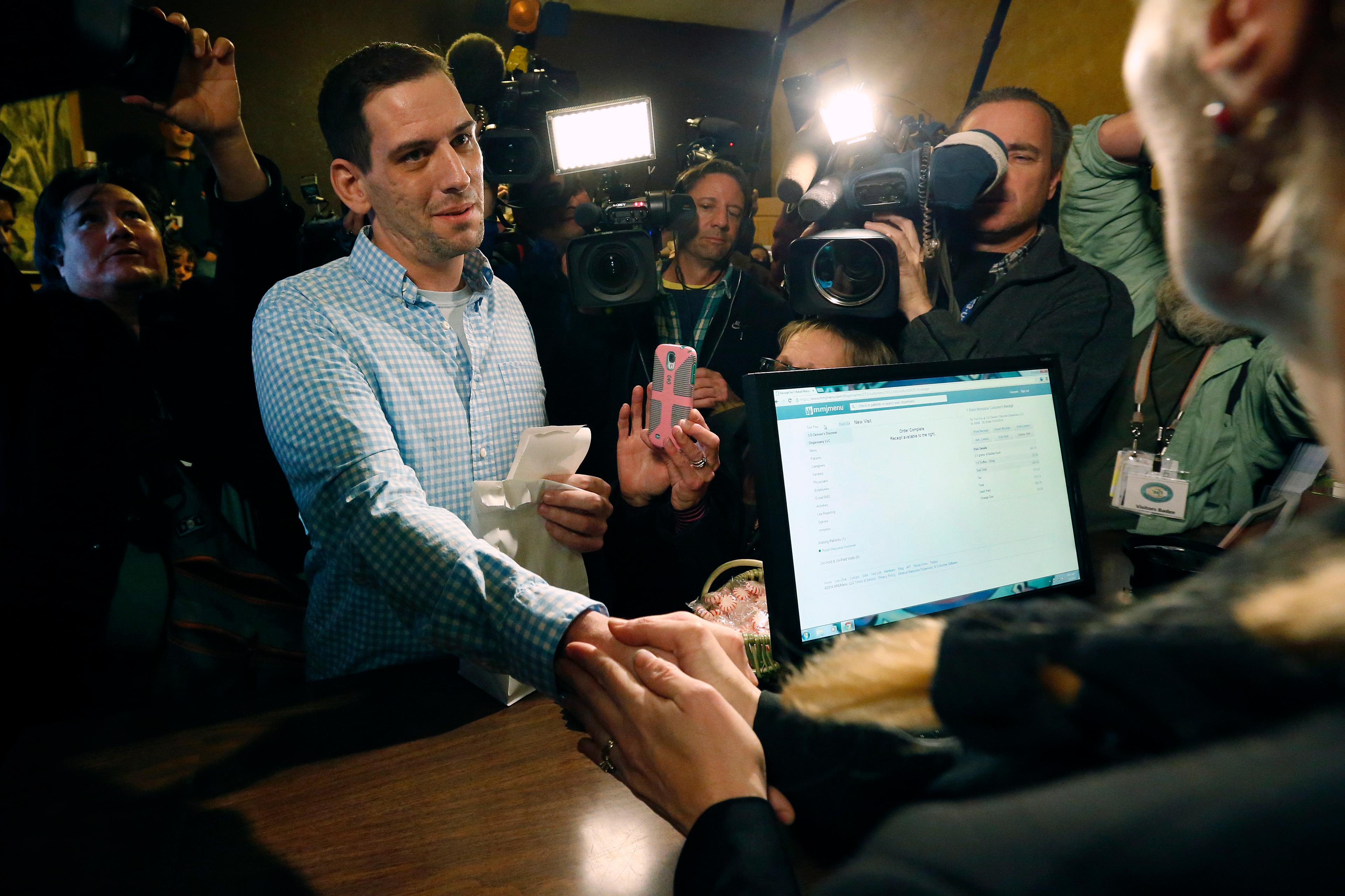 Photo: First legal retail marijuana sale (AP Photo)