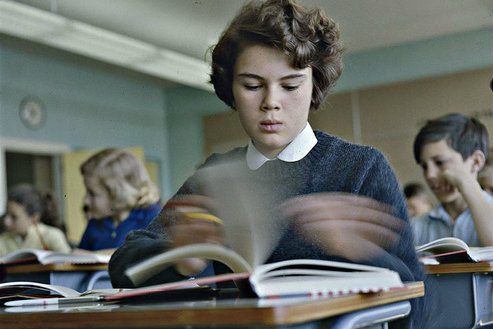 Photo: Student in class with book