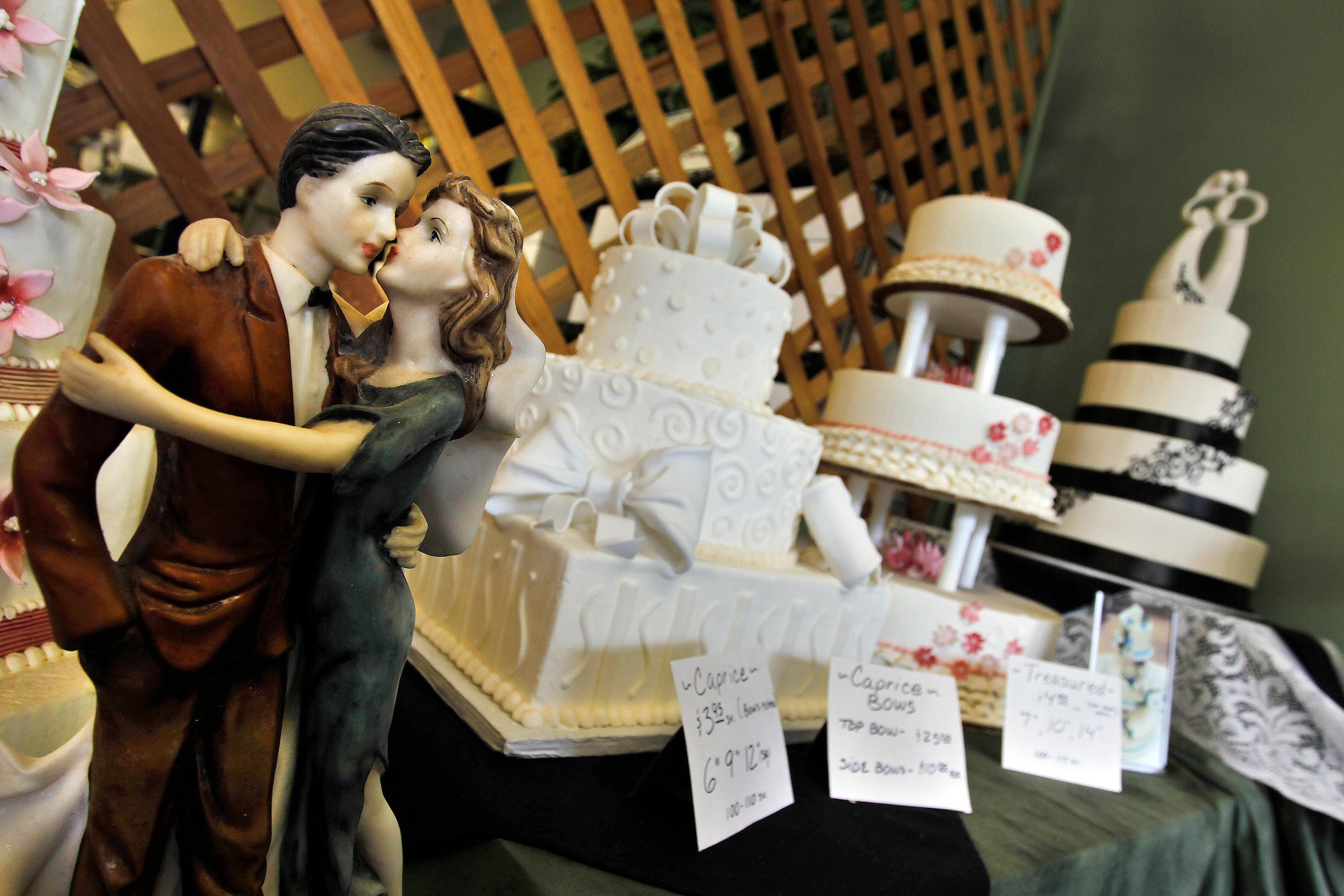 Photo: Figurines are depicted in an embrace at a wedding cake display at Masterpiece Cakeshop, in Denver,