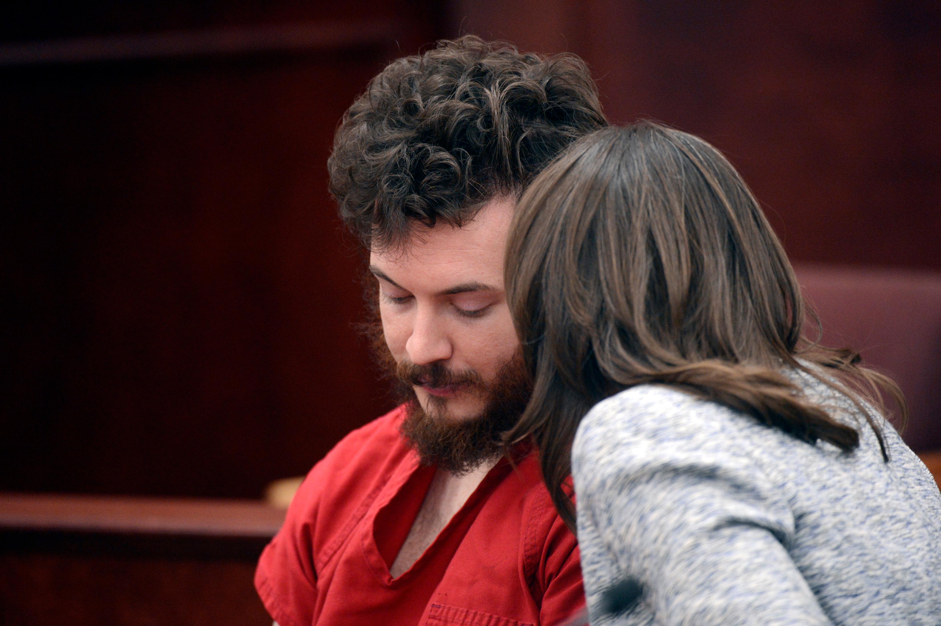 Photo: James Holmes listens to his defense attorney Tamara Brady in court