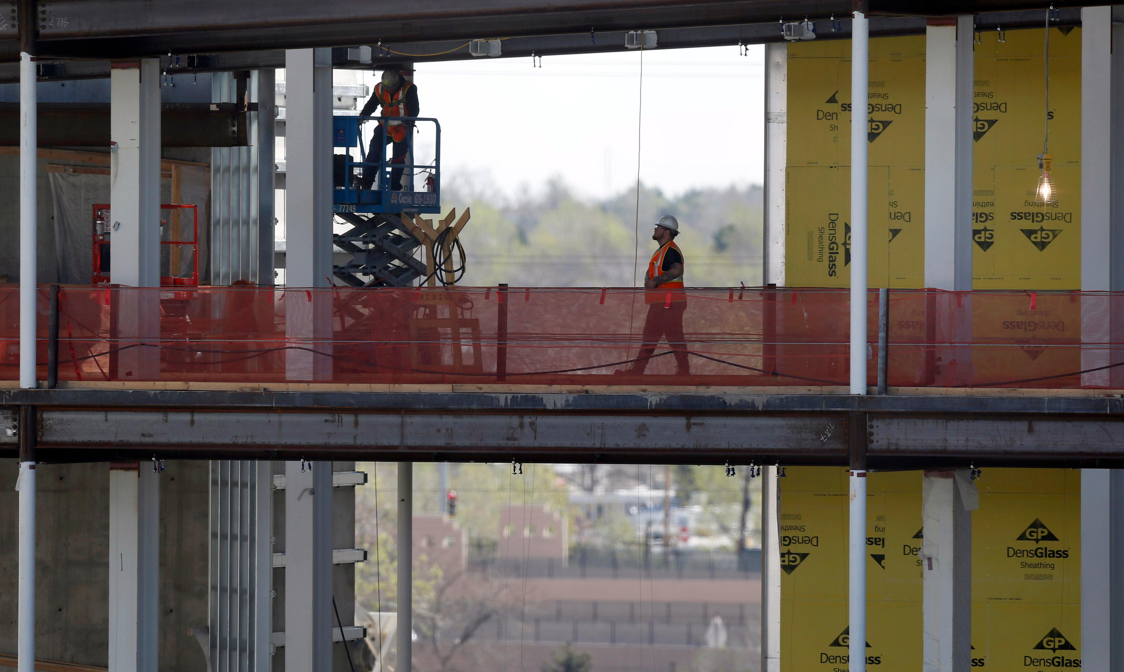 Photo: Aurora VA Hospital construction April 2015 3, silhouetted man walking (AP Photo)