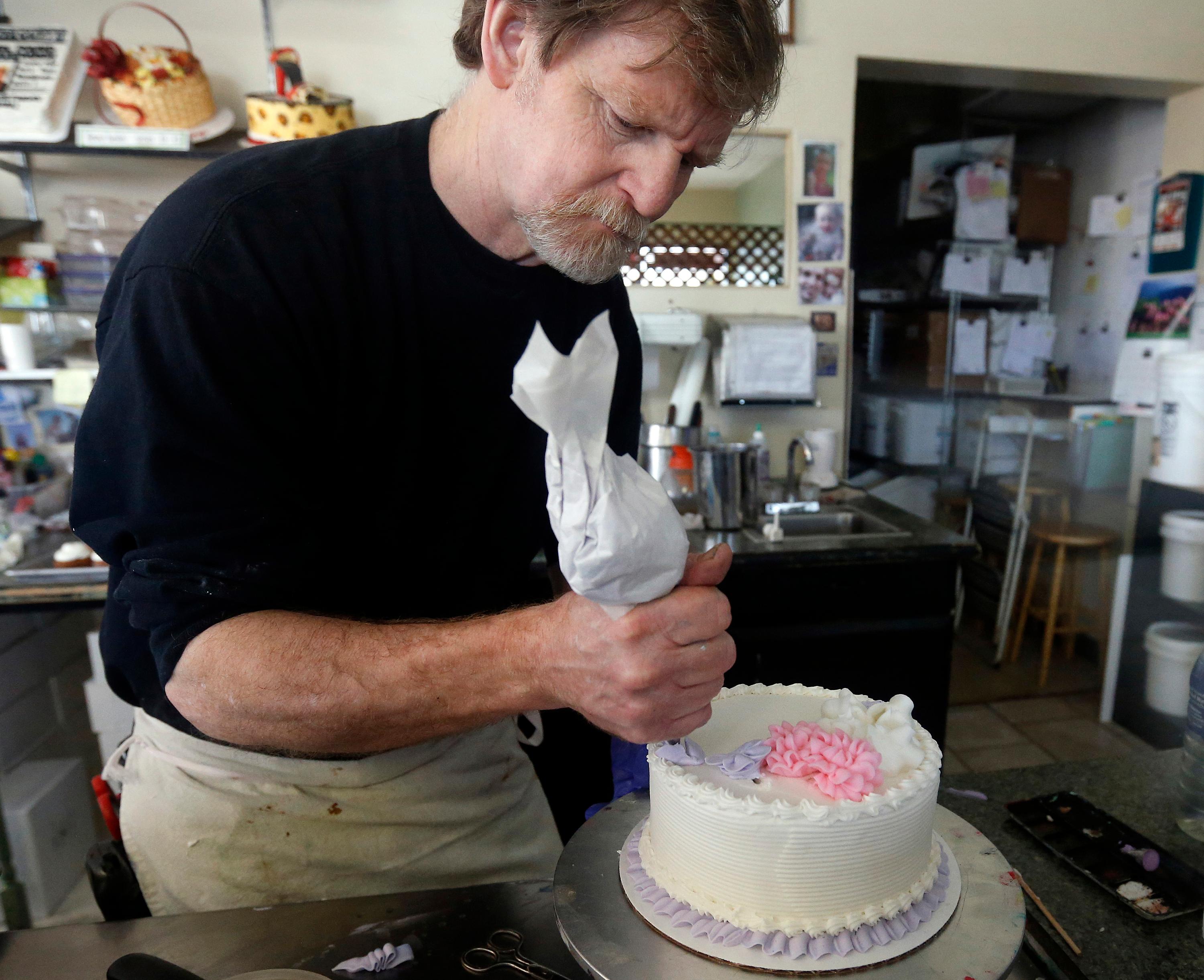 Photo: Masterpiece Cakeshop owner Jack Phillips decorates a cake March 10, 2014