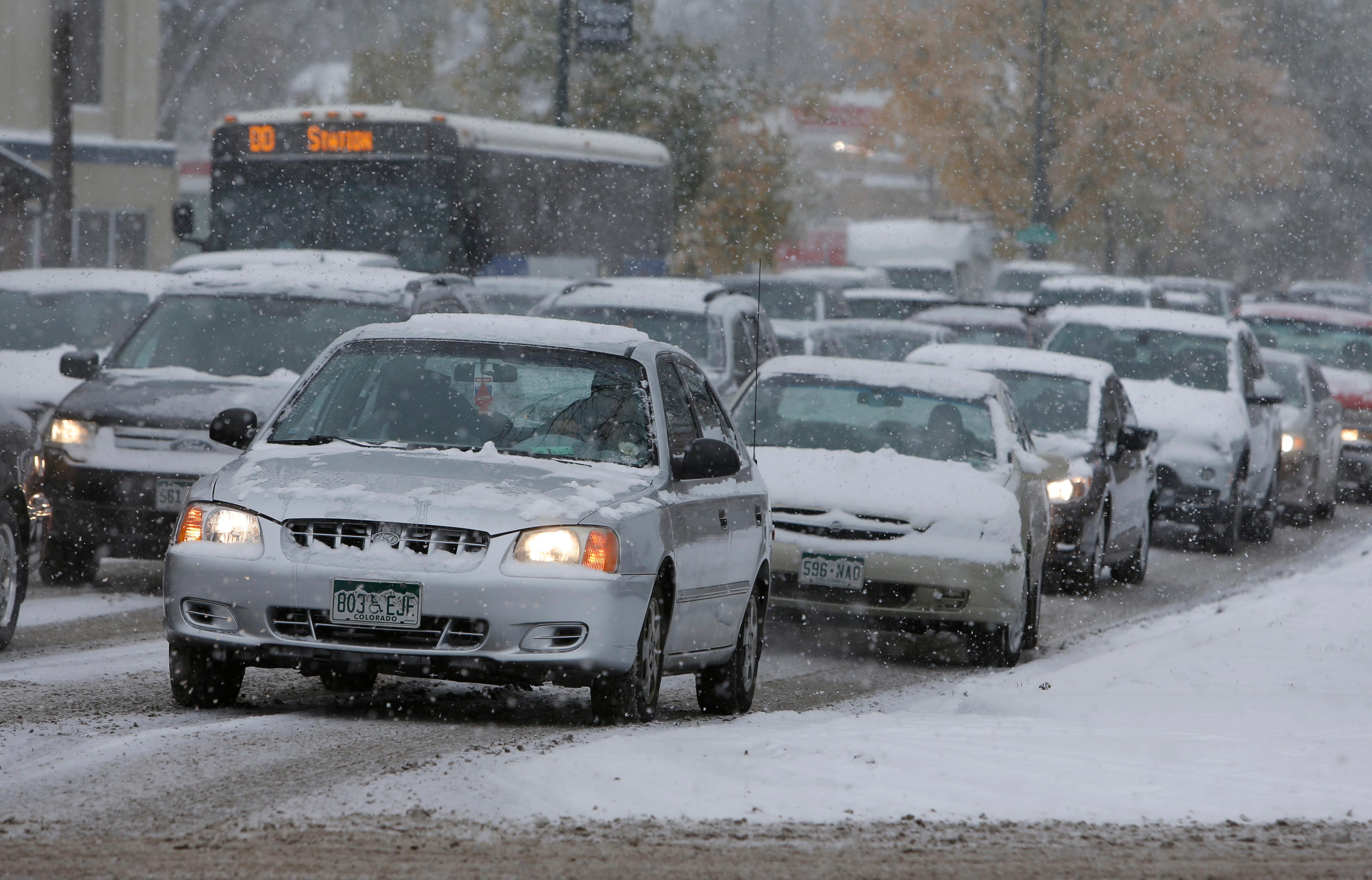 Photo: Snowy traffic along Speer (AP Photo)