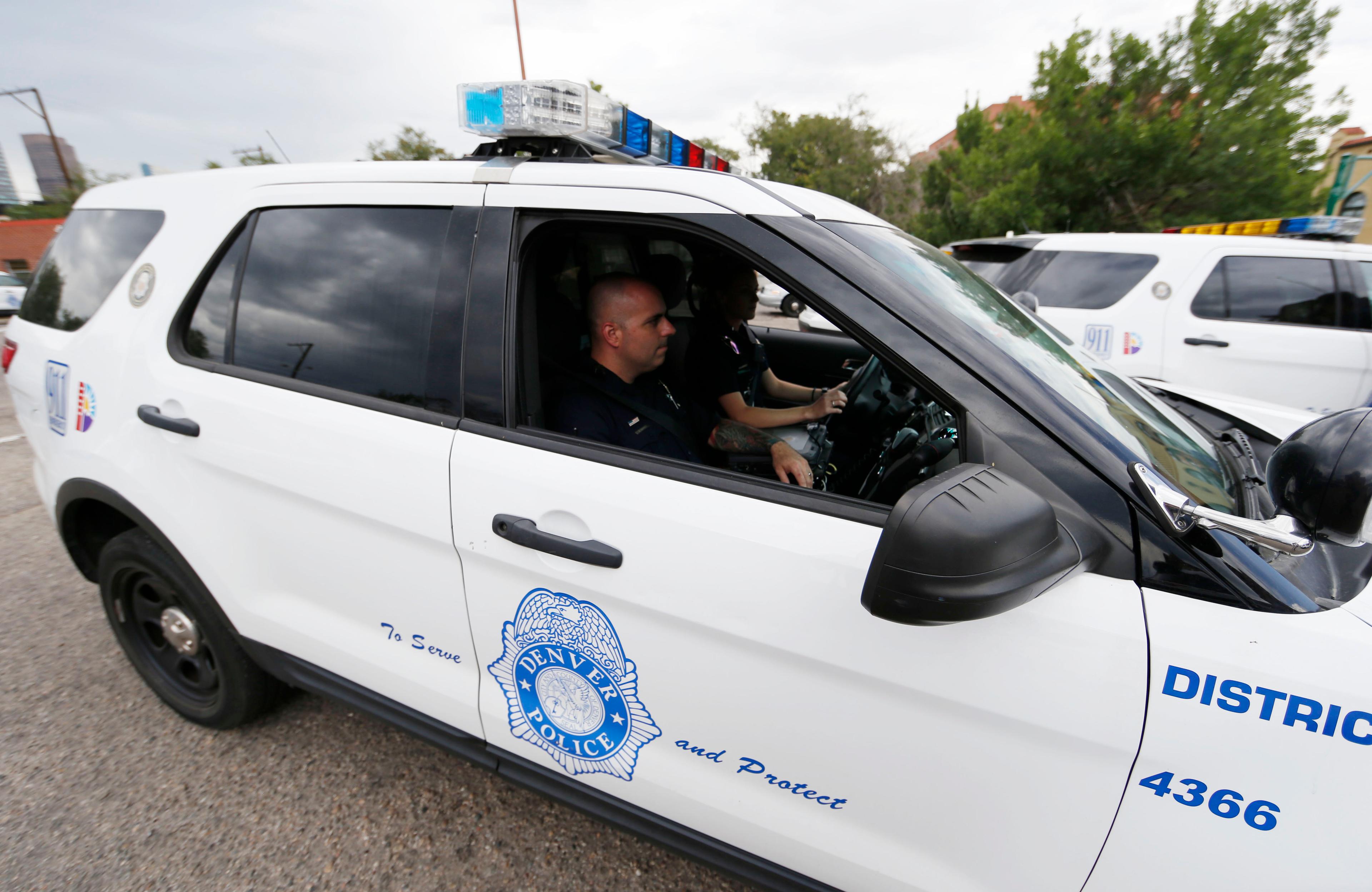 Photo: Denver Police Department officers in patrol car (AP Photo)