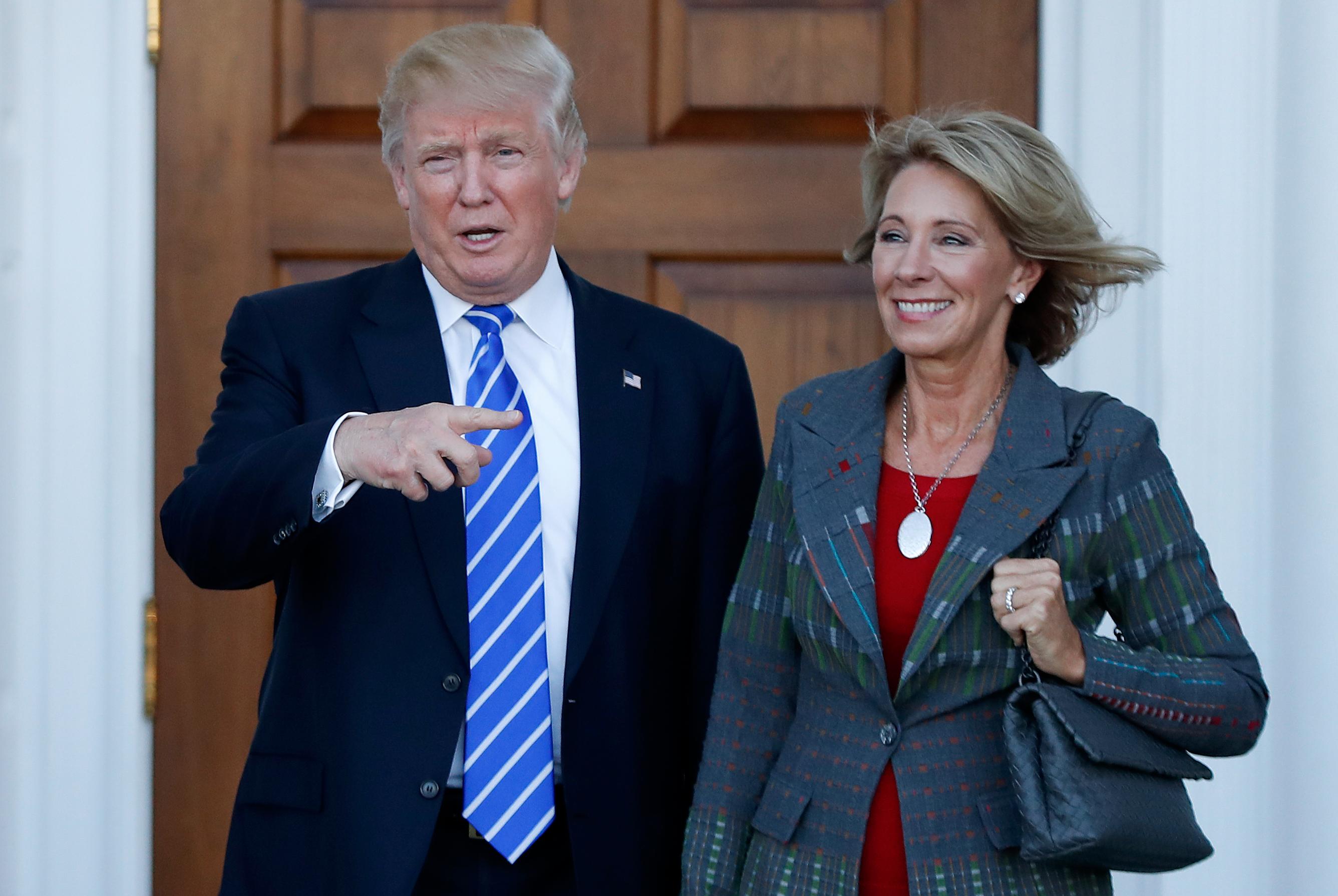Photo: Donald Trump, Betsy DeVos (AP Photo)