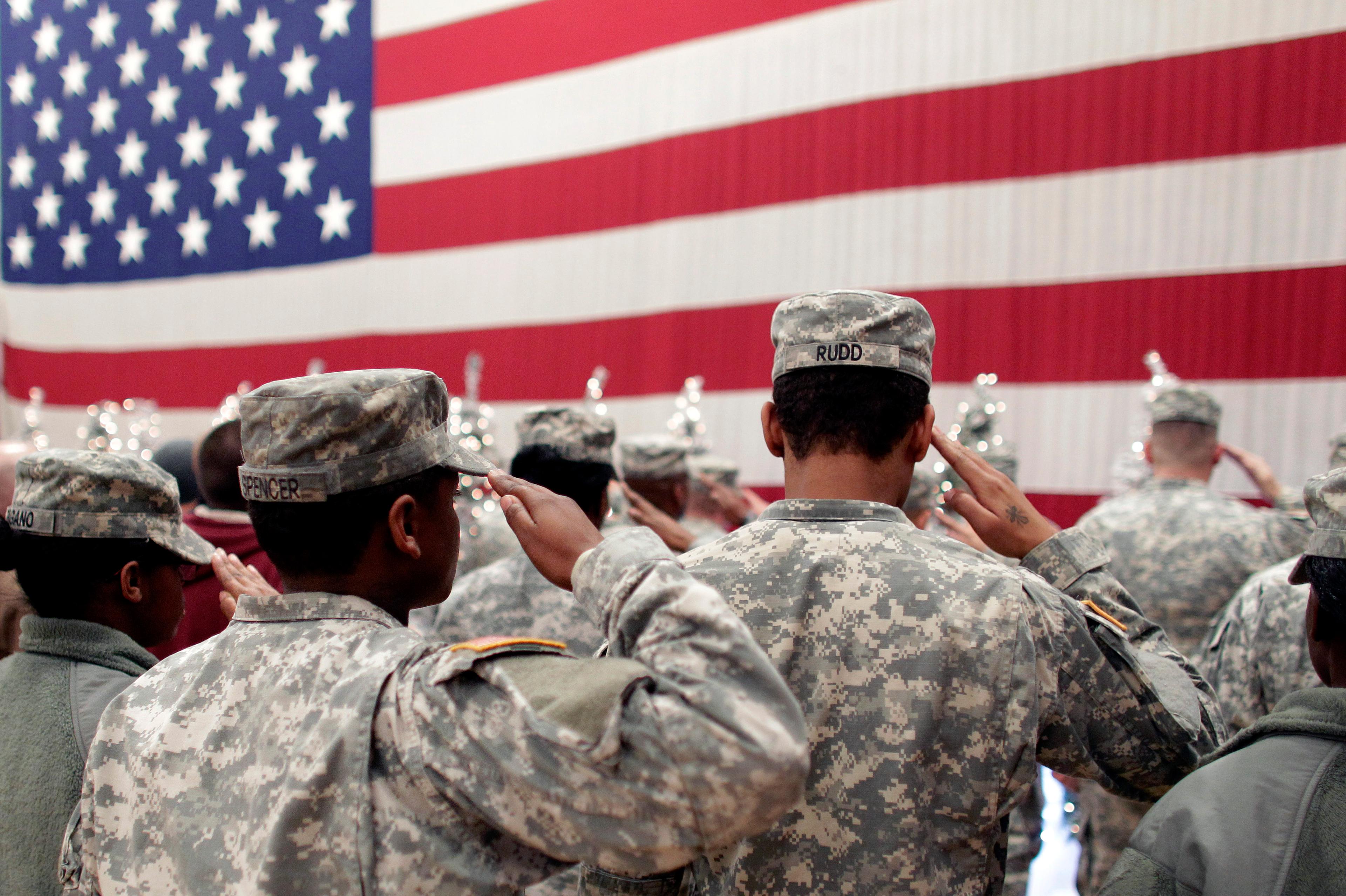 Photo: Soldiers Salute Flag Return To Fort Carson 2012 (AP File)