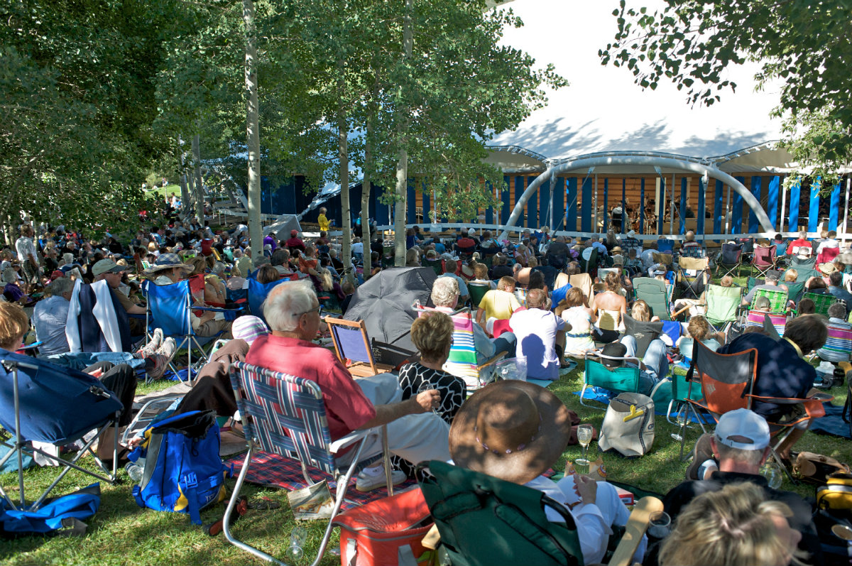 Festival attendees sit in lawn chairs outside Aspen Music Festival's Benedict Music Tent