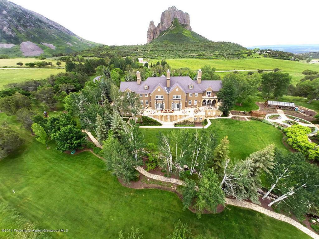 Photo shows an aerial view of Joe Cocker's mansion in Crawford, CO. It is surrounded by grass and trees.