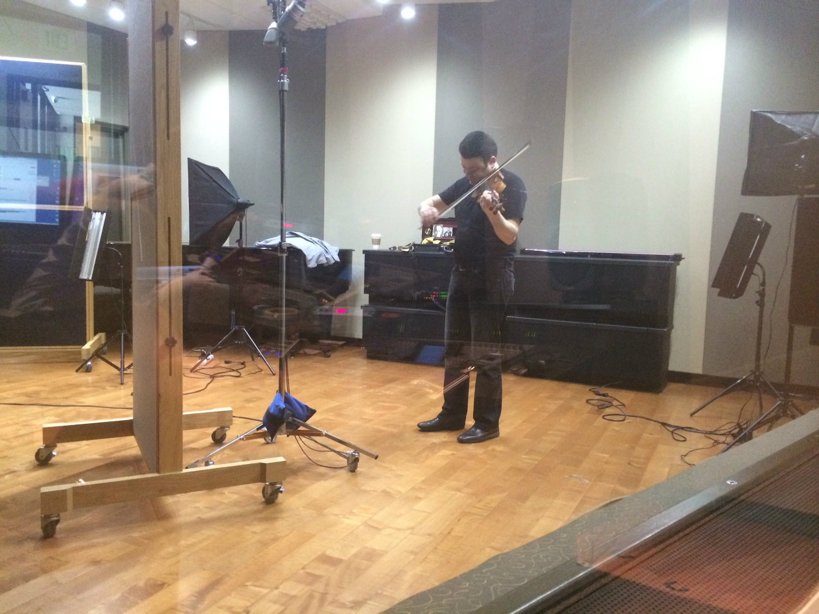 Photo: Violinist Vadim Gluzman behind the glass in the CPR Performance Studio