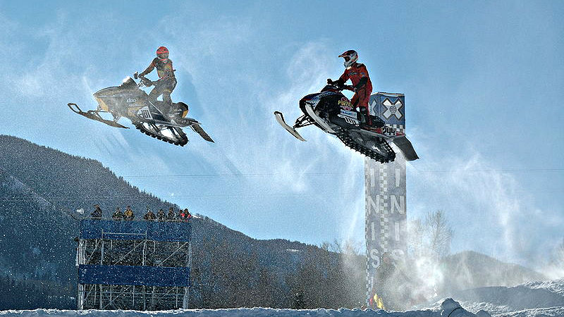 Photo: Snowmobiles jump at the X Games