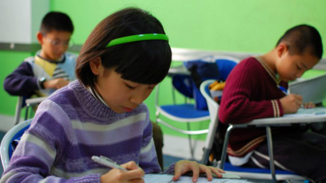 Photo: Testing (Asian girl at desk)