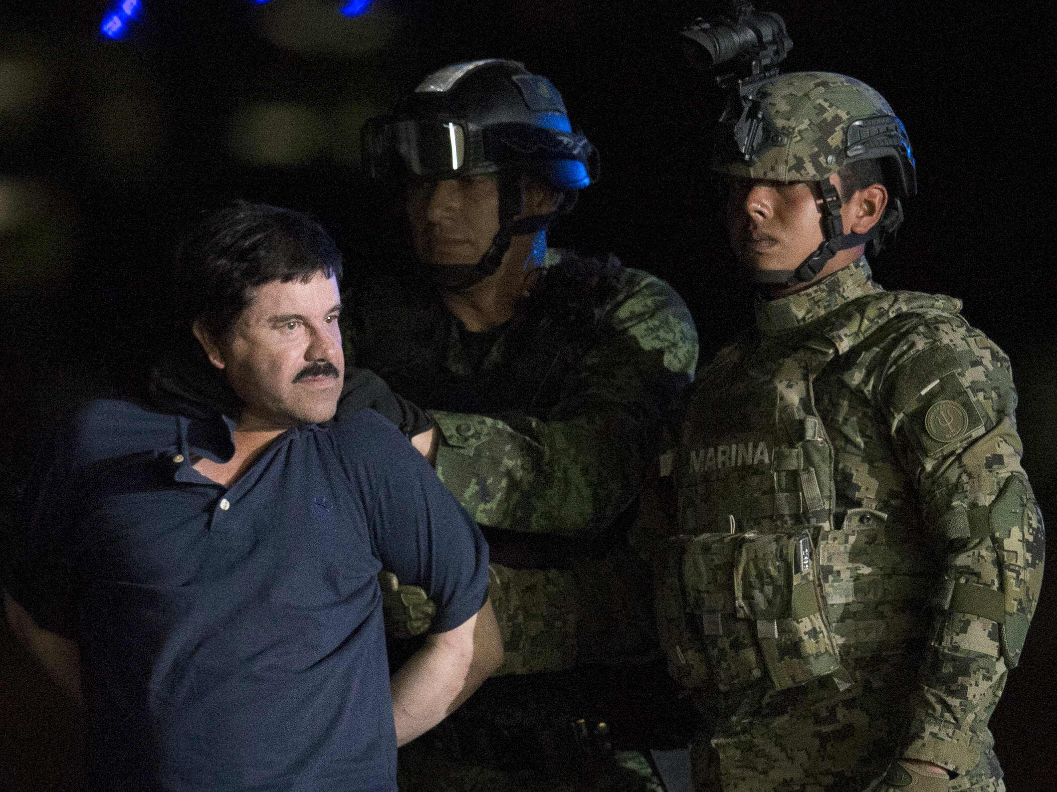 Joaquin Guzman El Chapo is taken to a federal hangar in Mexico by Mexican army soldiers in 2016.