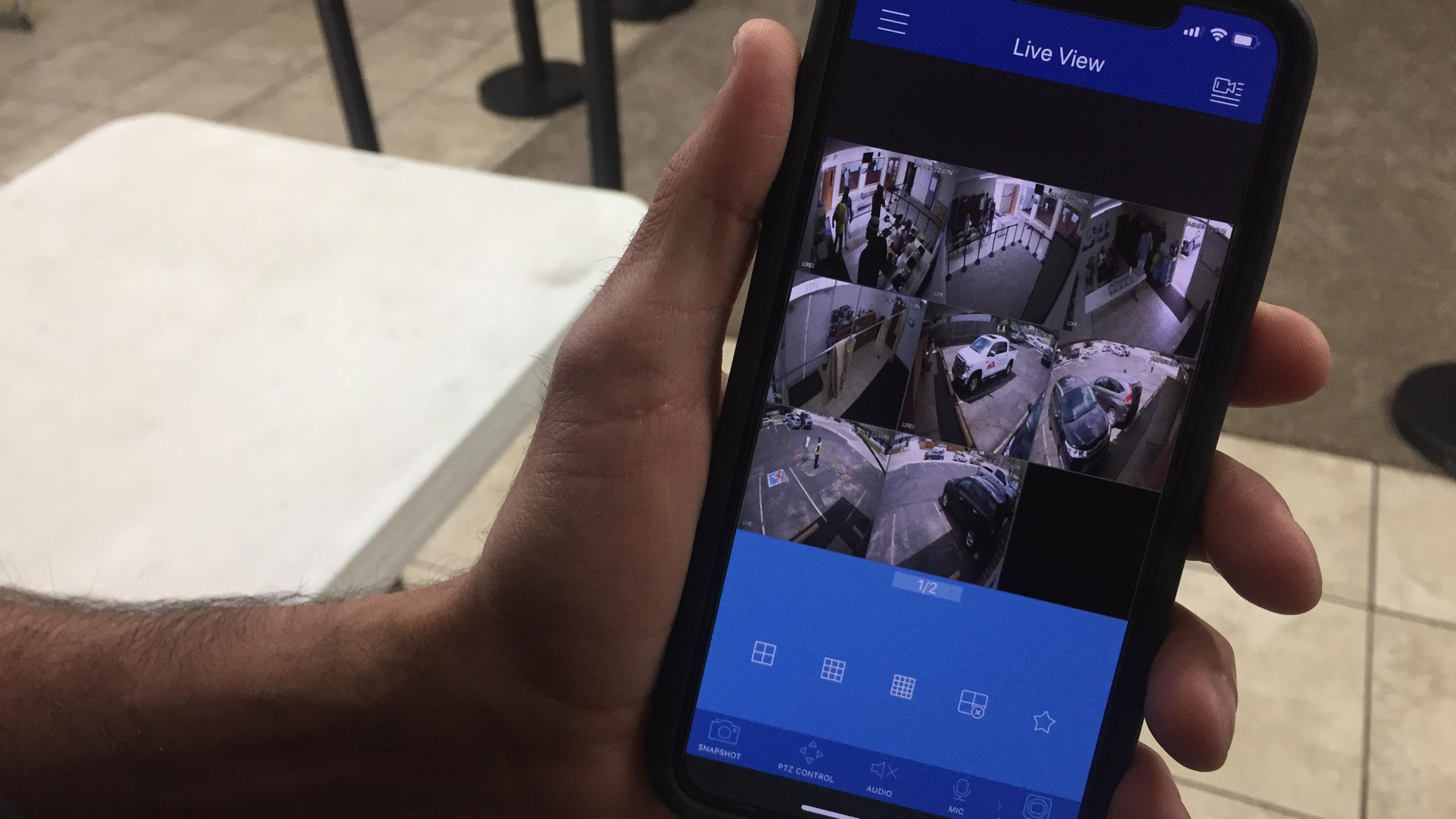 kamel-elwazeir-holding-phone-with-surveillance-app