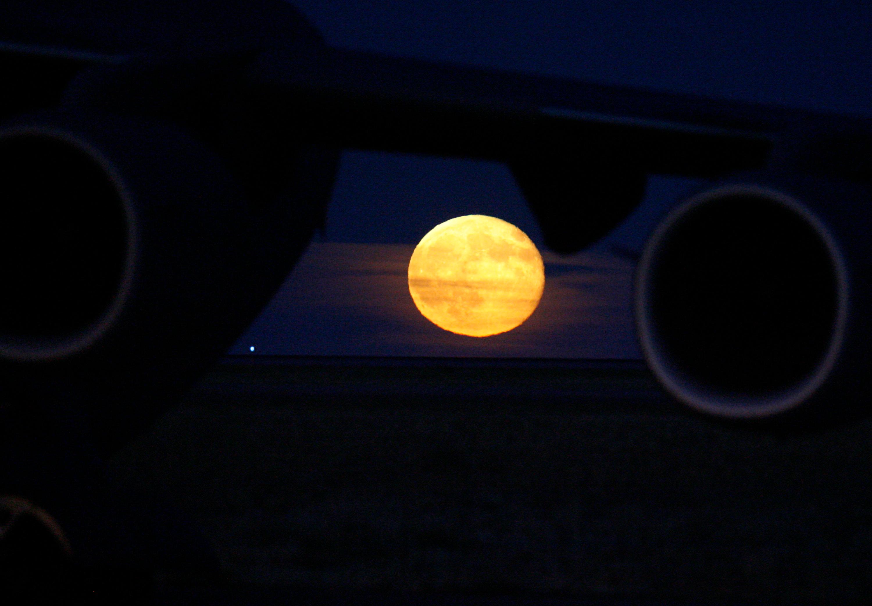 Harvest moon rises over Colorado prairie