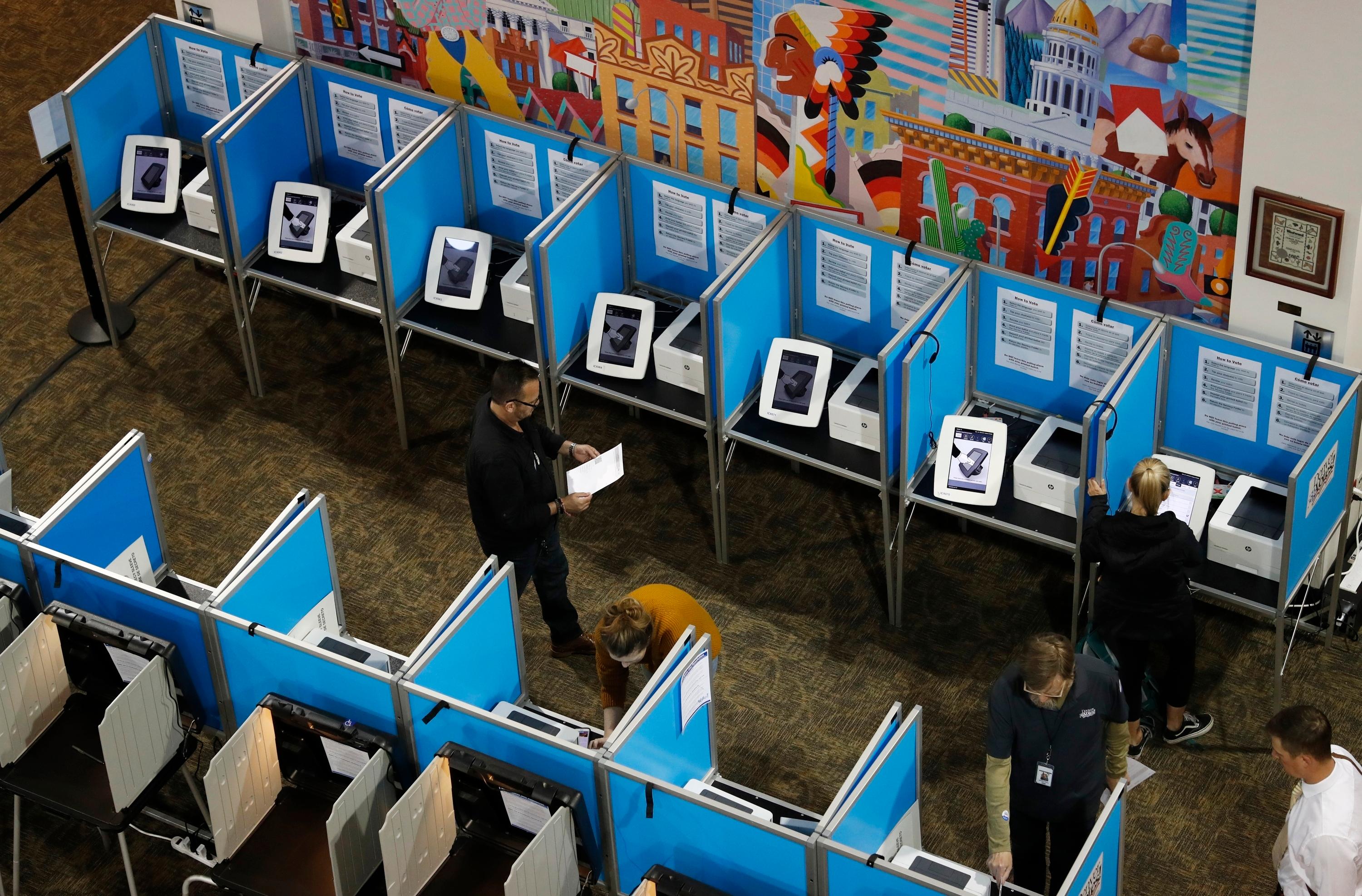 Voters fill out their ballots at the Denver Elections Division Tuesday, May 7, 2019, in Denver.