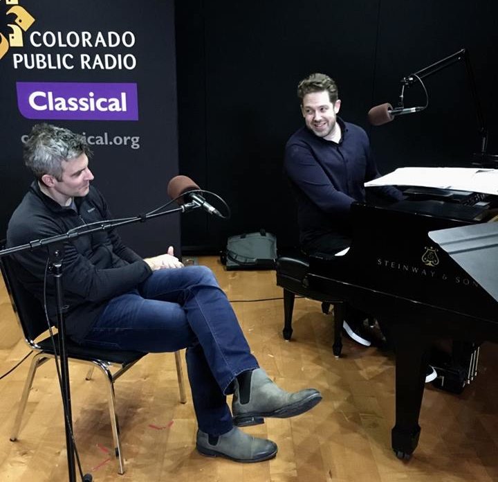 Kevin Puts sits in front of a microphone while Brett Mitchell sits at the piano in the CPR Performance Studio