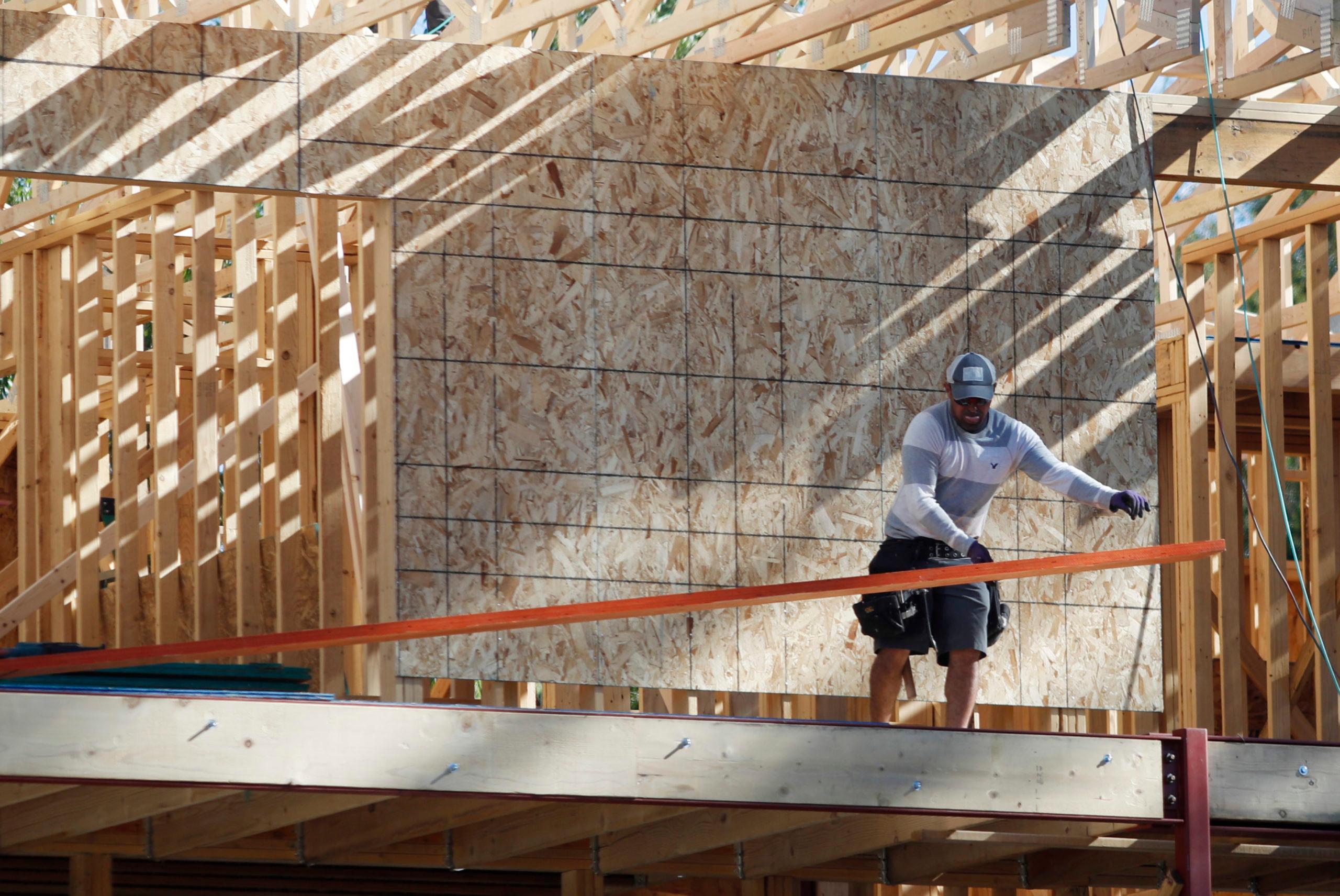 worker toils on new construction in denver, r m, housing, real estate, construction, economy