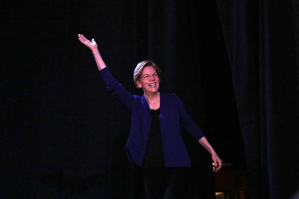 Elizabeth Warren waves to supporters as she walks on stage at the Fillmore in Denver Sunday, Feb.23, 2020.