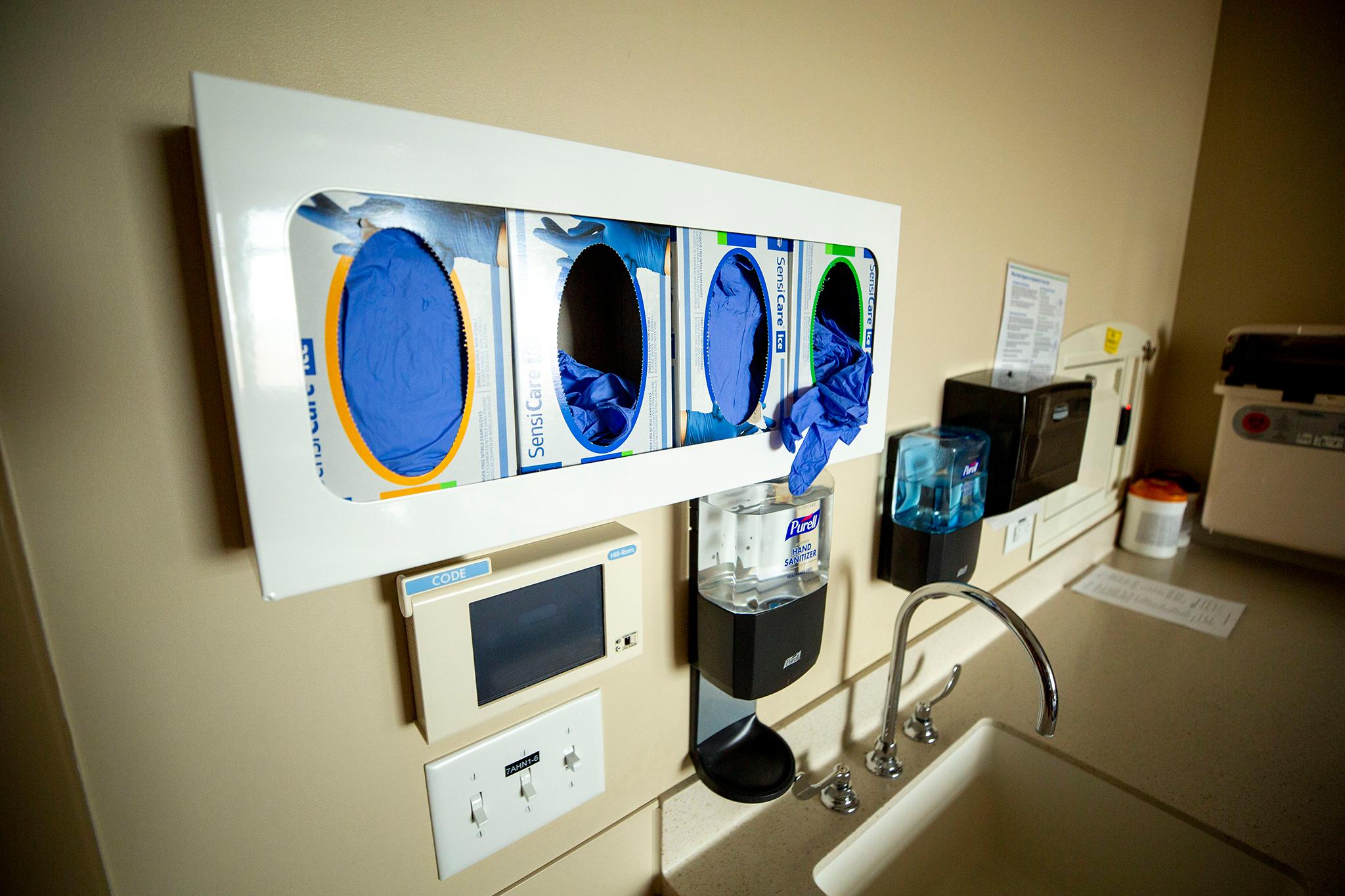 Glove boxes on the wall inside a room at St. Joseph Hospital, March 10, 2020.