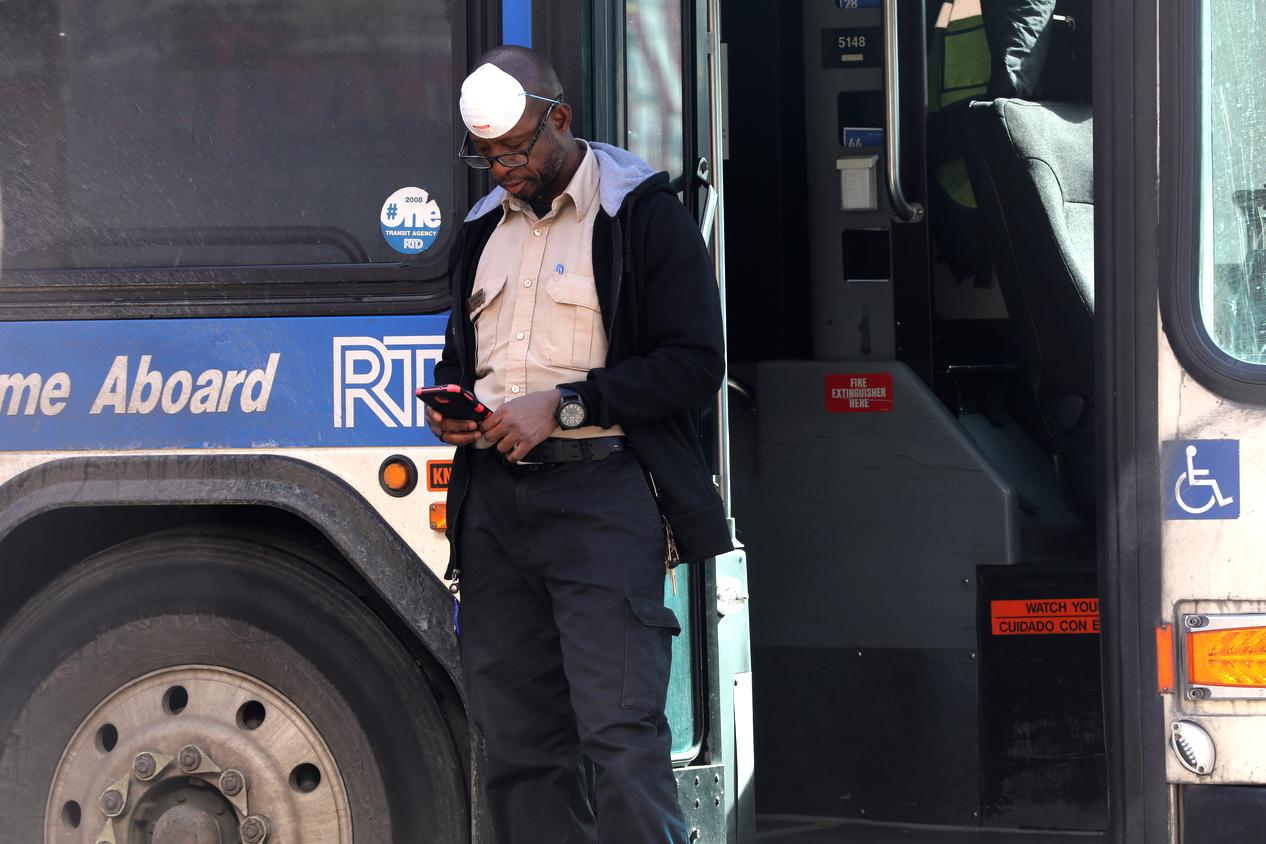 An RTD driver with a face mask pulled up.