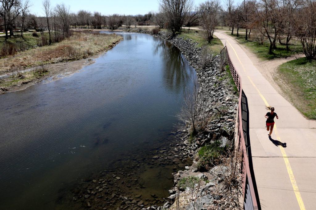 A runner beside the South Platte River in Littleton