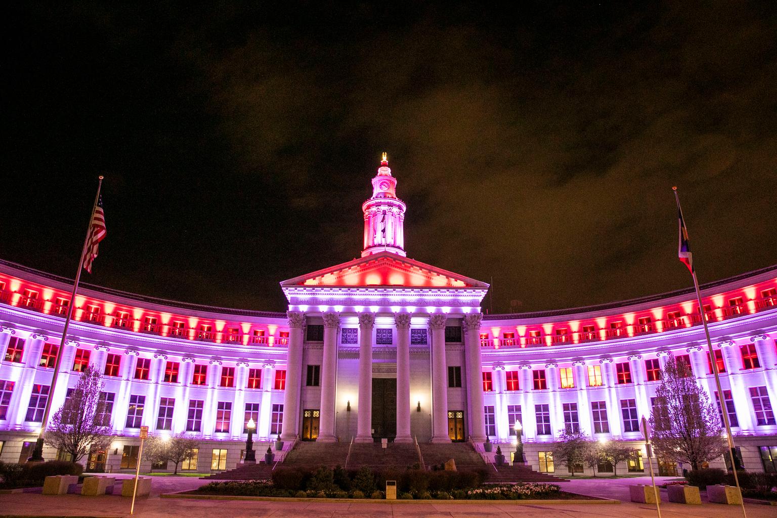 Denver City and County Building lit in red and white first responders coronavirus