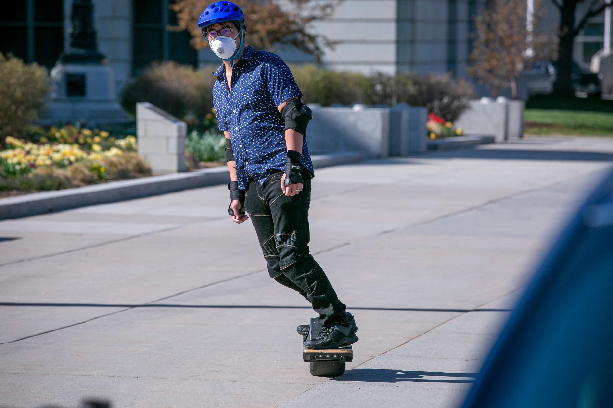 Riding the deserted sidewalk between Denver’s City and County Building and Bannock Street