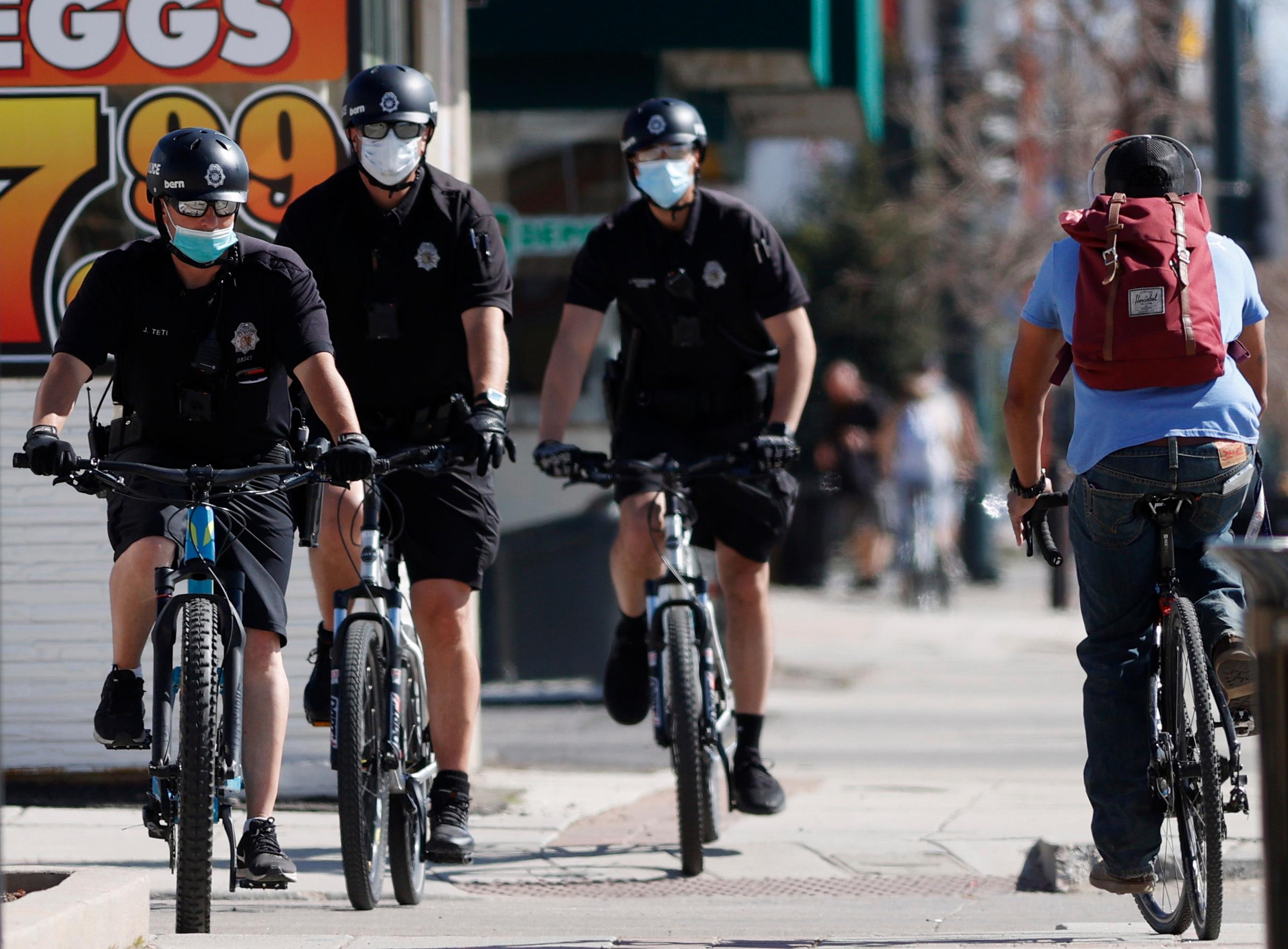 Denver Police Department bicycle patrol in face masks, r m