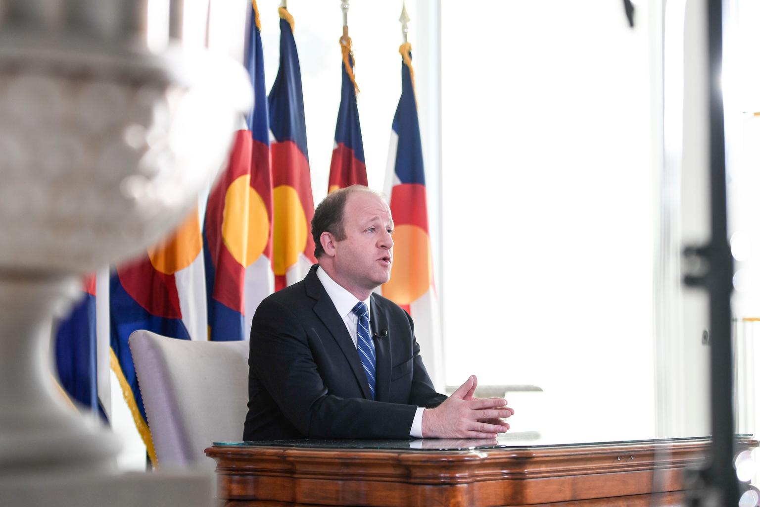 Jared Polis delivers an address from the governor&#039;s mansion on Monday, April 6