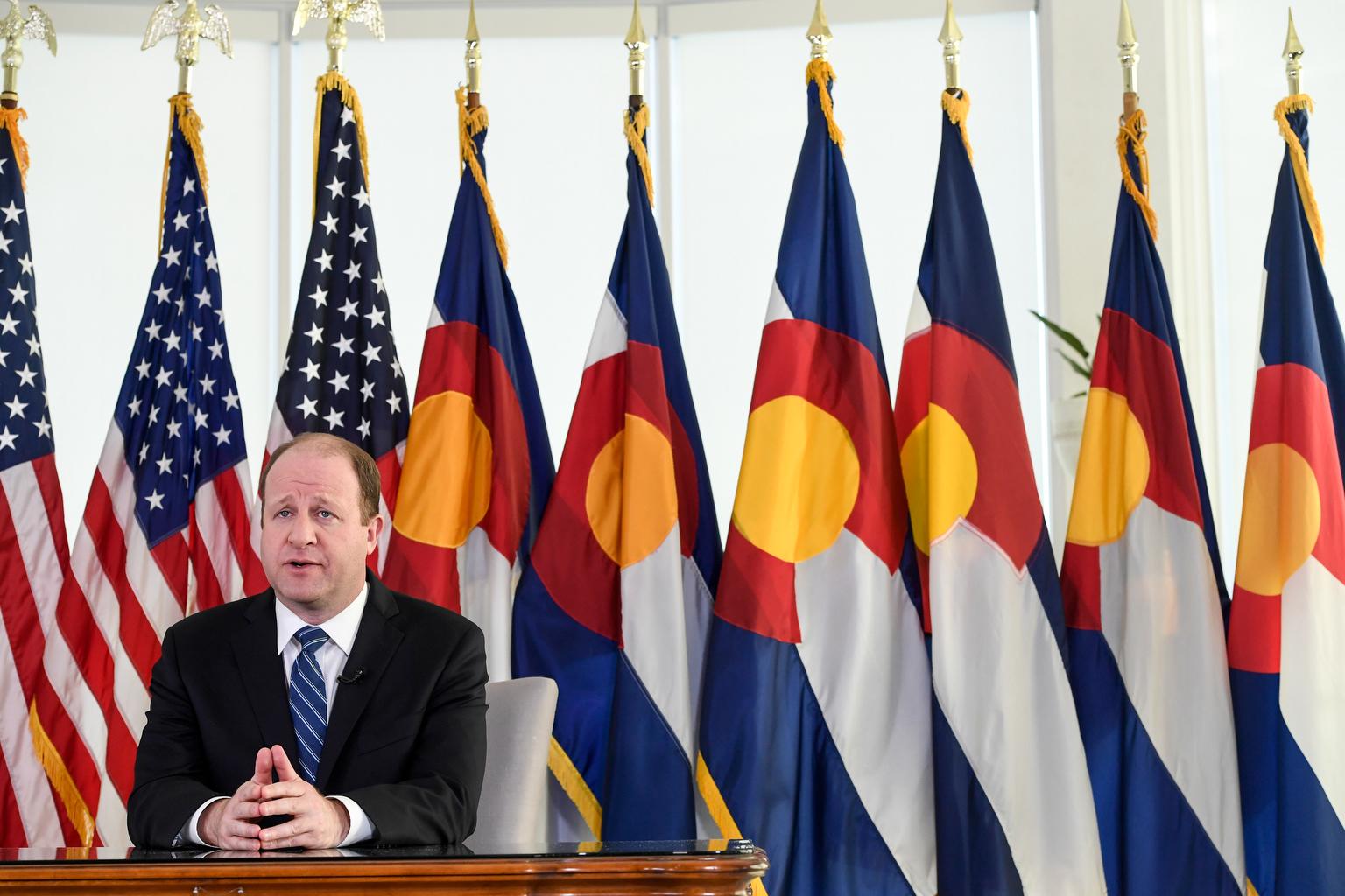 Jared Polis delivers an address from the governor&#039;s mansion on Monday, April 6