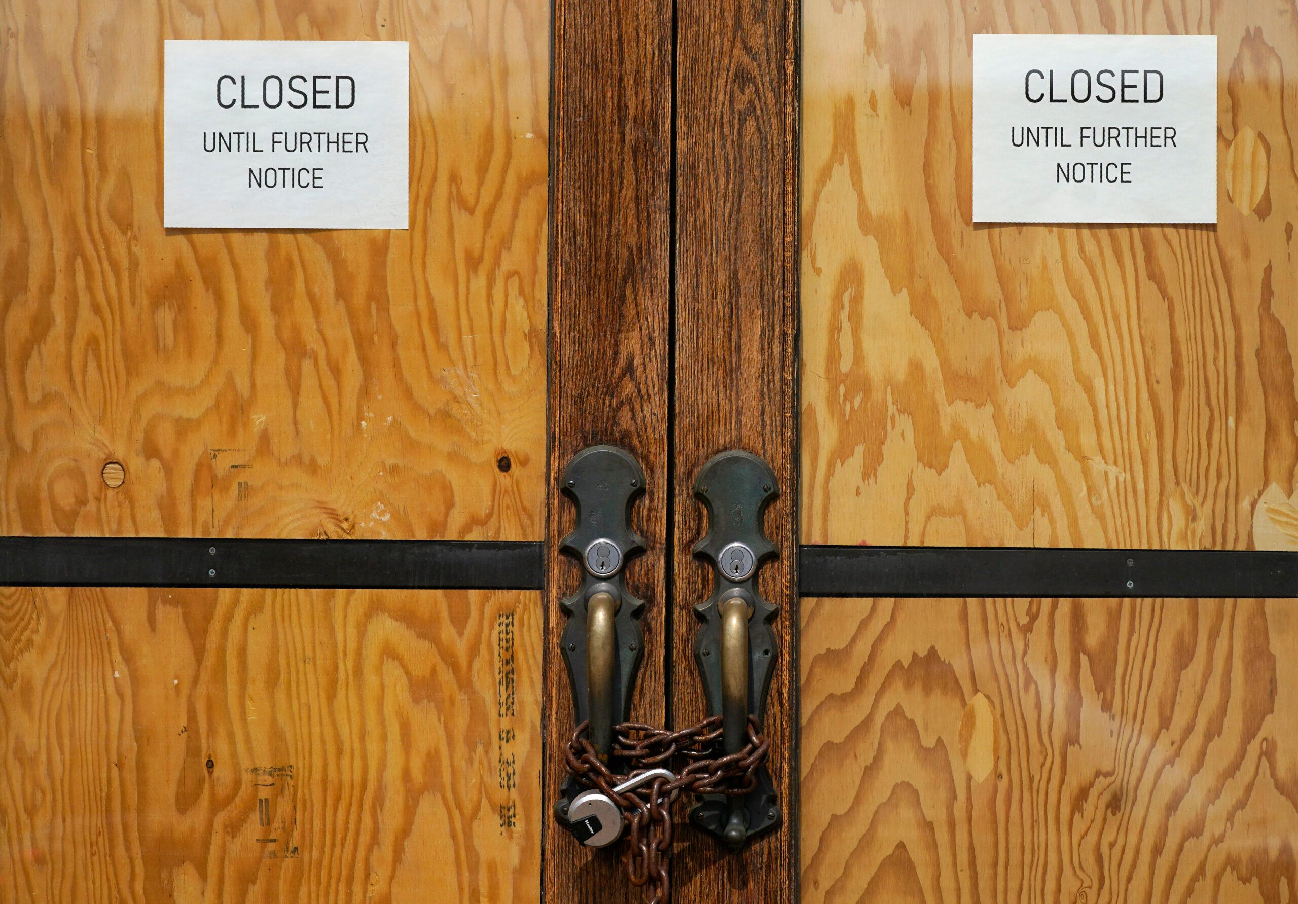 The front doors of a closed restaurant