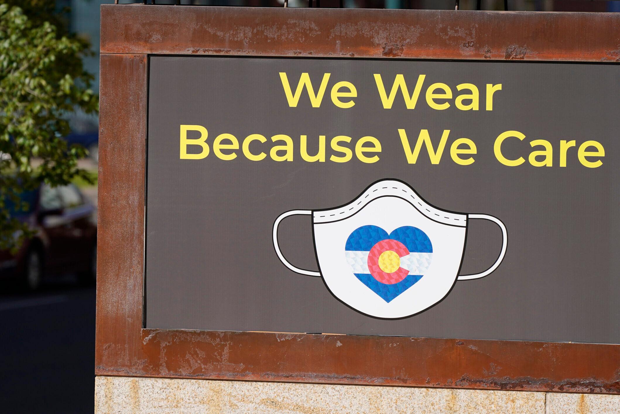 A sign in Denver encourages face masks.