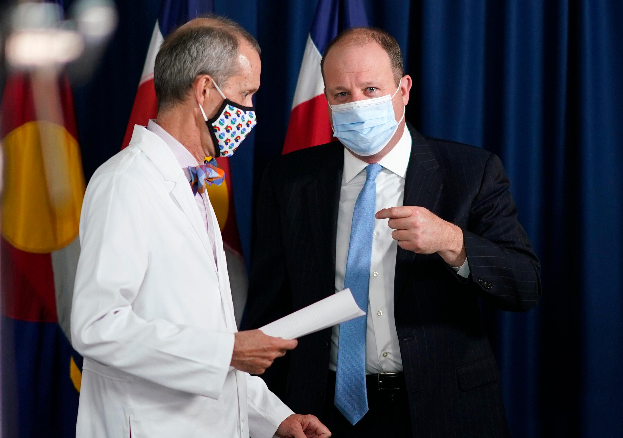 Gov. Jared Polis speaks with Dr. Eric France.