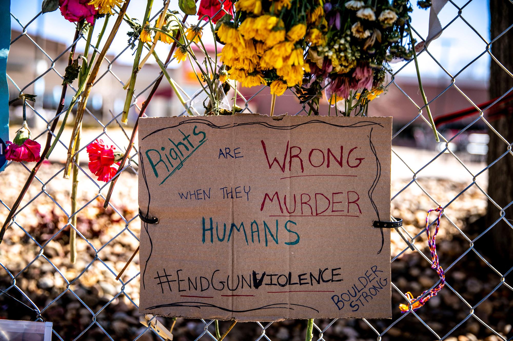 210329-BOULDER-SHOOTING-MEMORIAL-FLOWERS-SIGNS