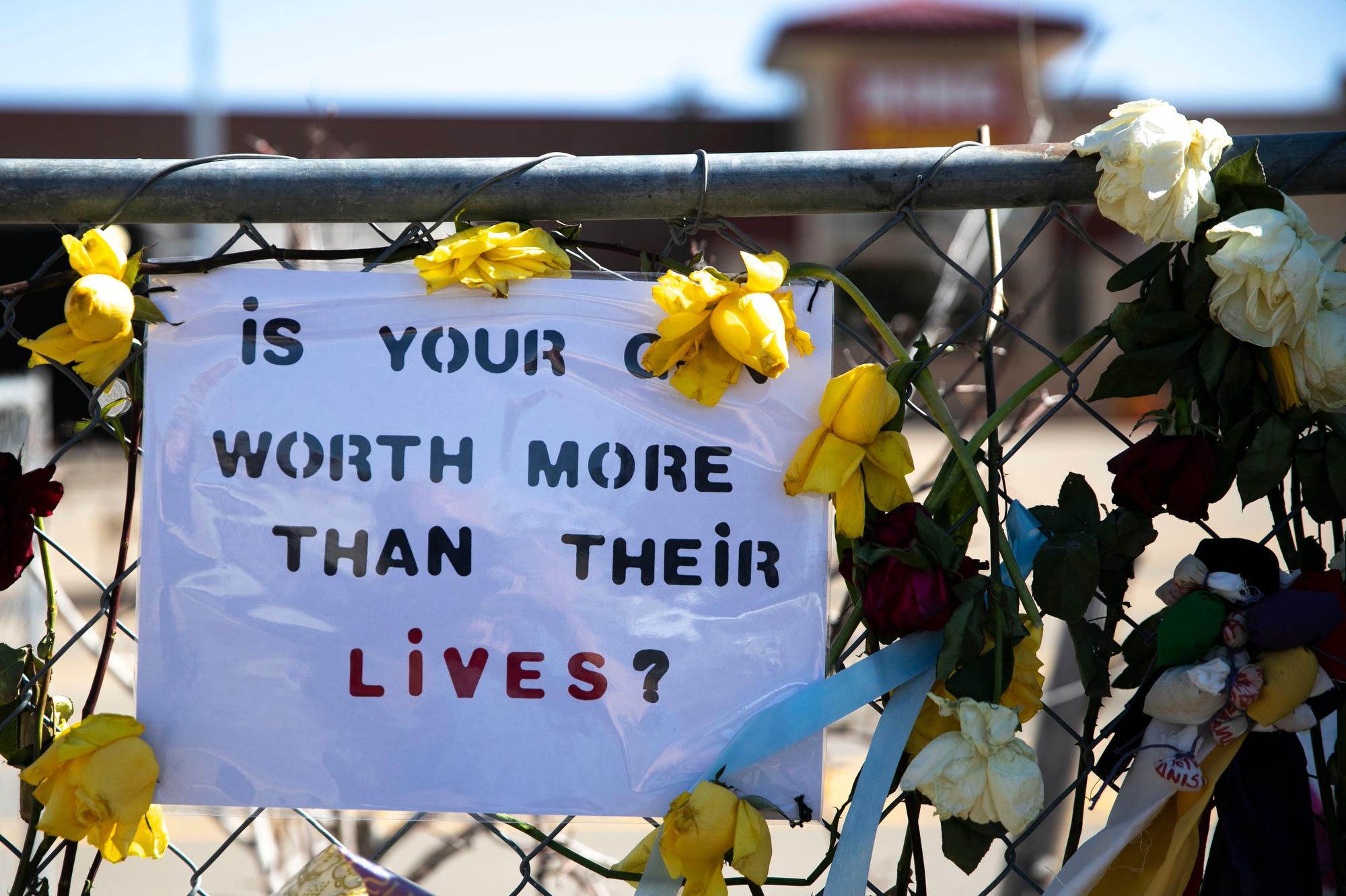 210329-BOULDER-SHOOTING-MEMORIAL-FLOWERS-SIGNS