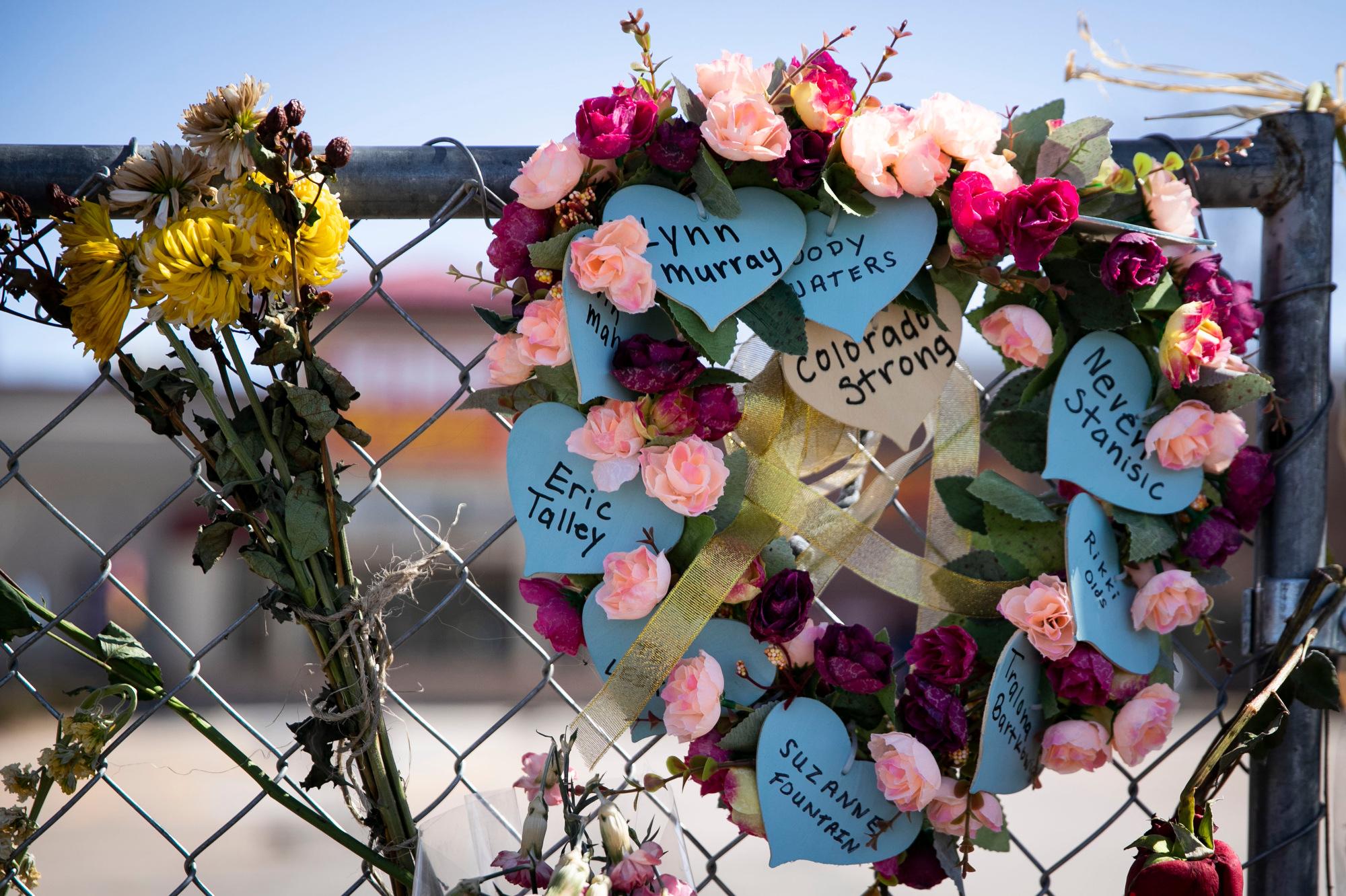 210329-BOULDER-SHOOTING-MEMORIAL-FLOWERS-SIGNS