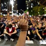 Khyra Parker raises her fist during nine minutes of silence during the sixth day of protests in reaction to the killing of George Floyd by Minneapolis police. June 2, 2020. (Kevin J. Beaty/Denverite)