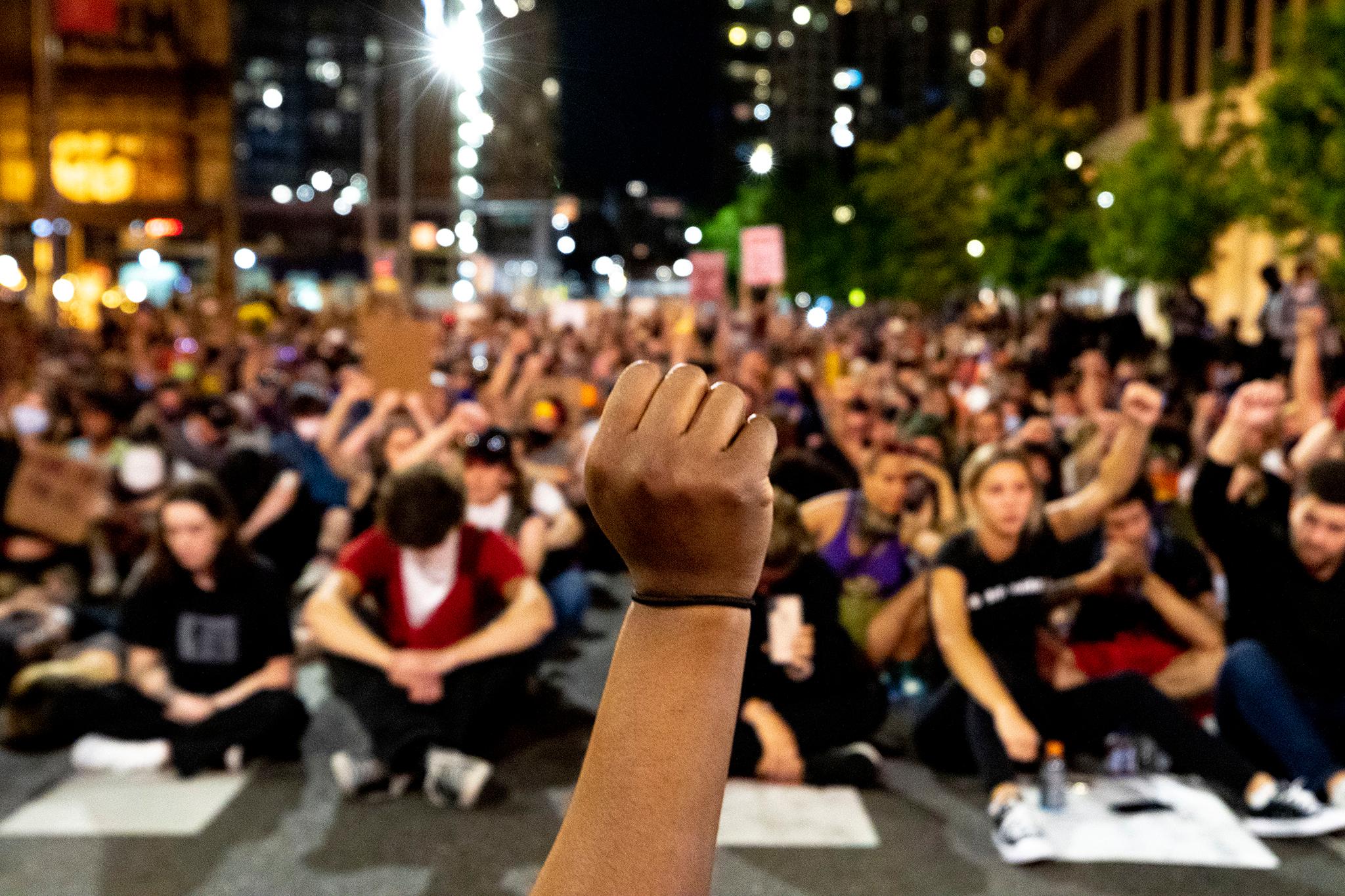 Khyra Parker raises her fist during nine minutes of silence during the sixth day of protests in reaction to the killing of George Floyd by Minneapolis police. June 2, 2020. (Kevin J. Beaty/Denverite)