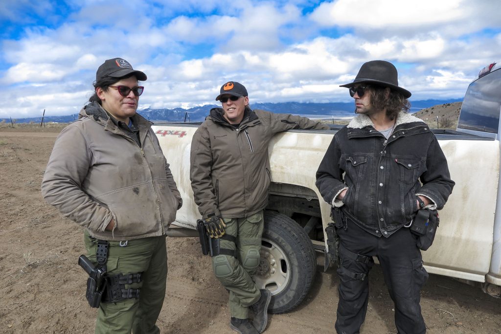 Tenacious Unicorn Ranch owners Bonnie Nelson and Penny Logue discuss heightened security measures on their property with ranch member J Stanley on April 28, 2021.