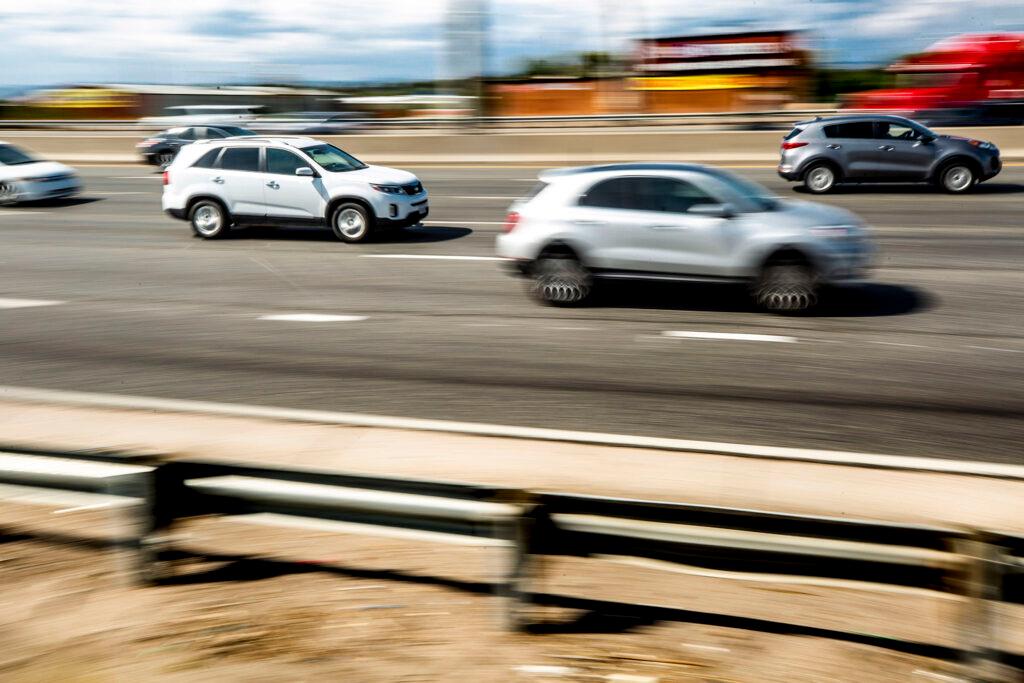 SUVs trek north on I-25 through Denver. Sept. 28, 2021.