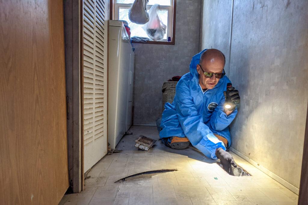 Neal Ashforth shines a light in a new vent at a home in Eagle County.