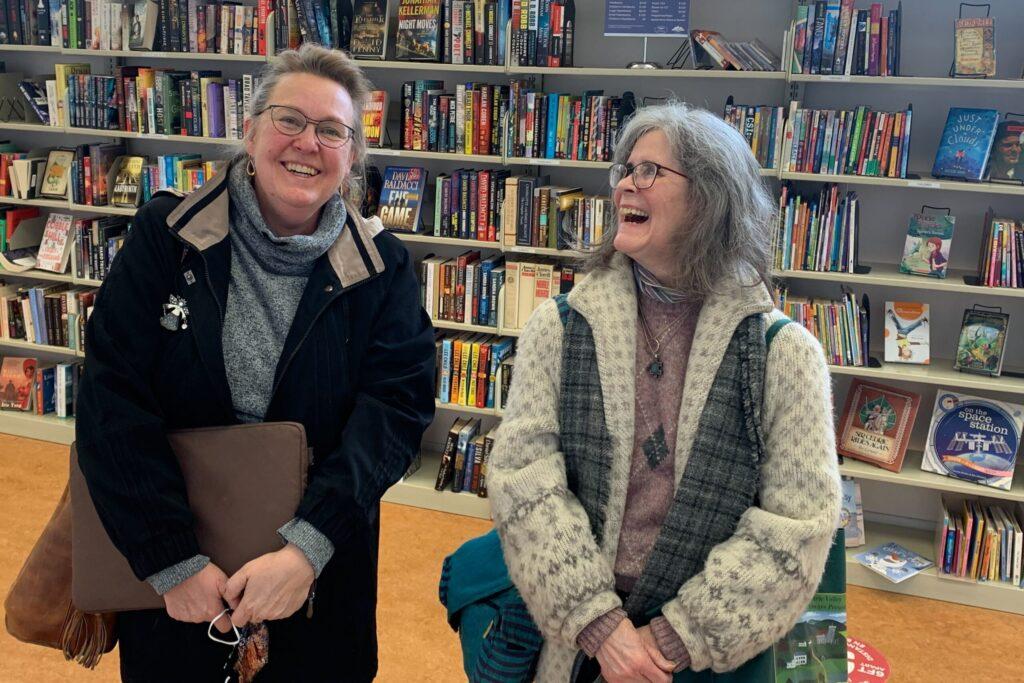Kathleen Harrison, left, and Gage Evans find some time for friendship and solidarity at the Arvada Public Library on Wednesday. They both lost their spouses in the Interstate 70 crash caused by a Texas trucker in 2019.