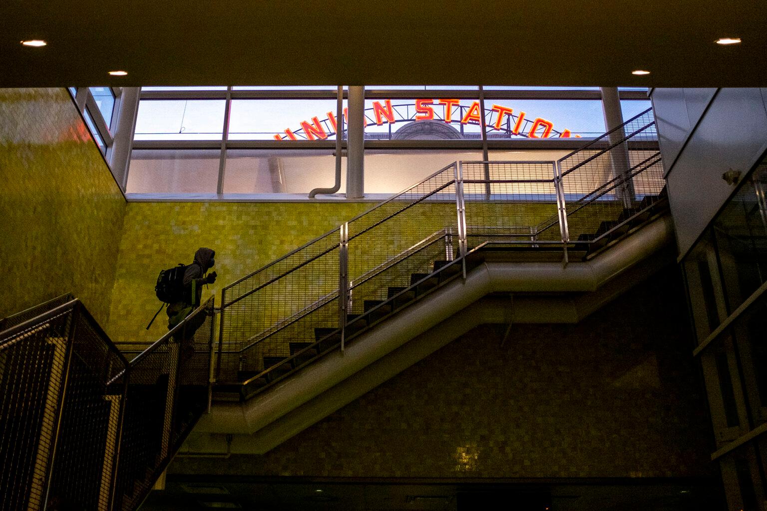 A man hikes up steps out of RTD&#039;s Union Station bus terminal. Dec. 8, 2021.