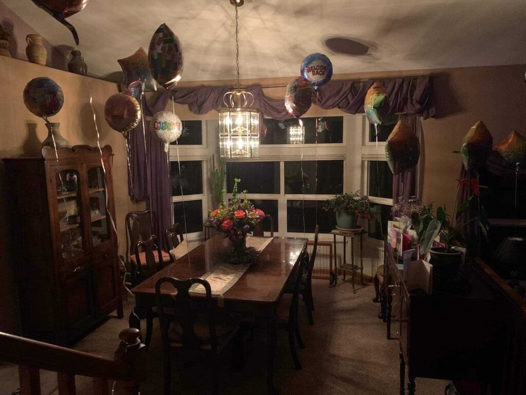 Balloons leftover from Annabelle Holblinger's 113th birthday party float around her daughter's dining room.
