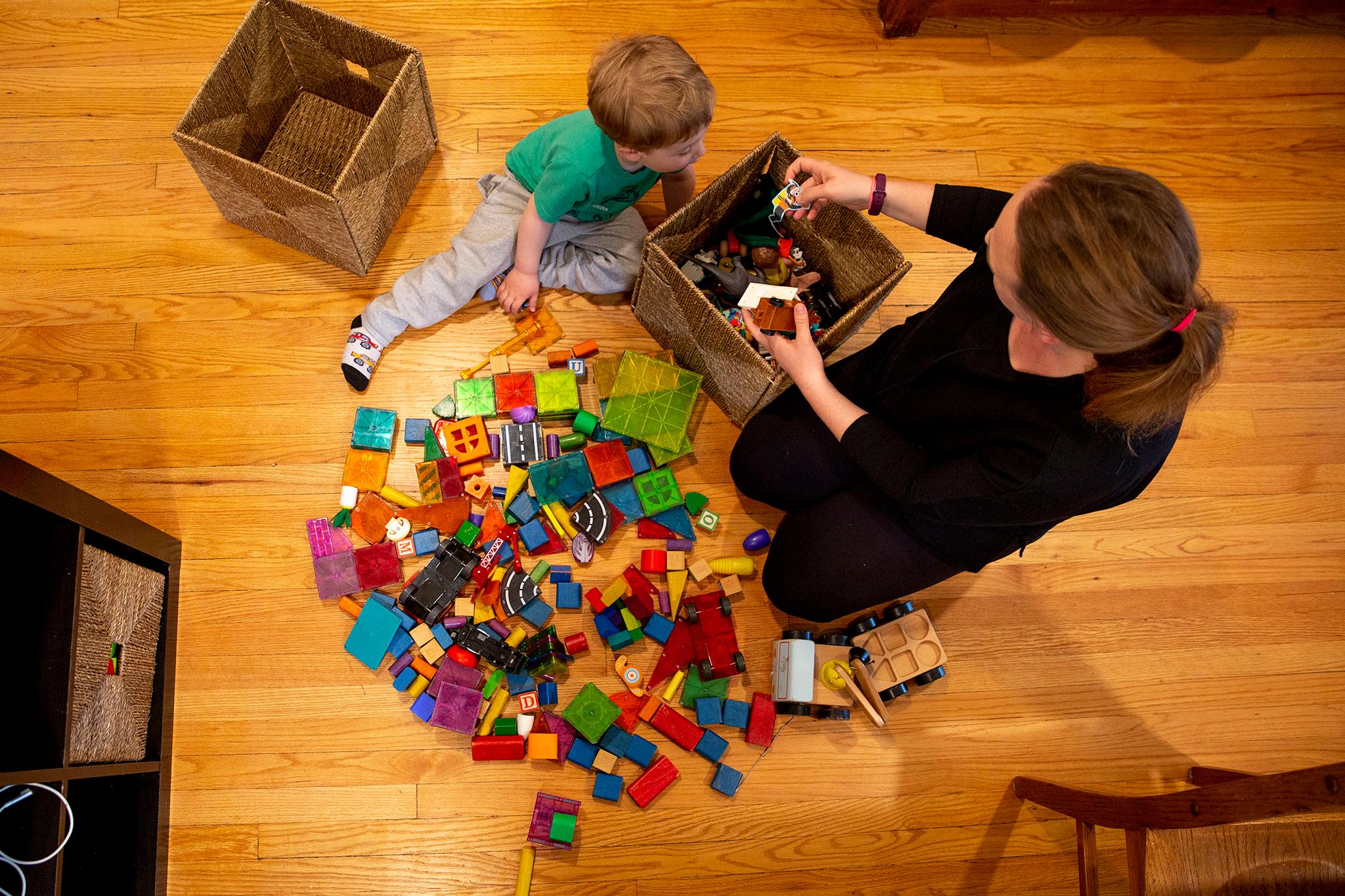 Beatrice Scheuermann and her son, Hans, play on the floor in their Congress Park home. March 22, 2022.